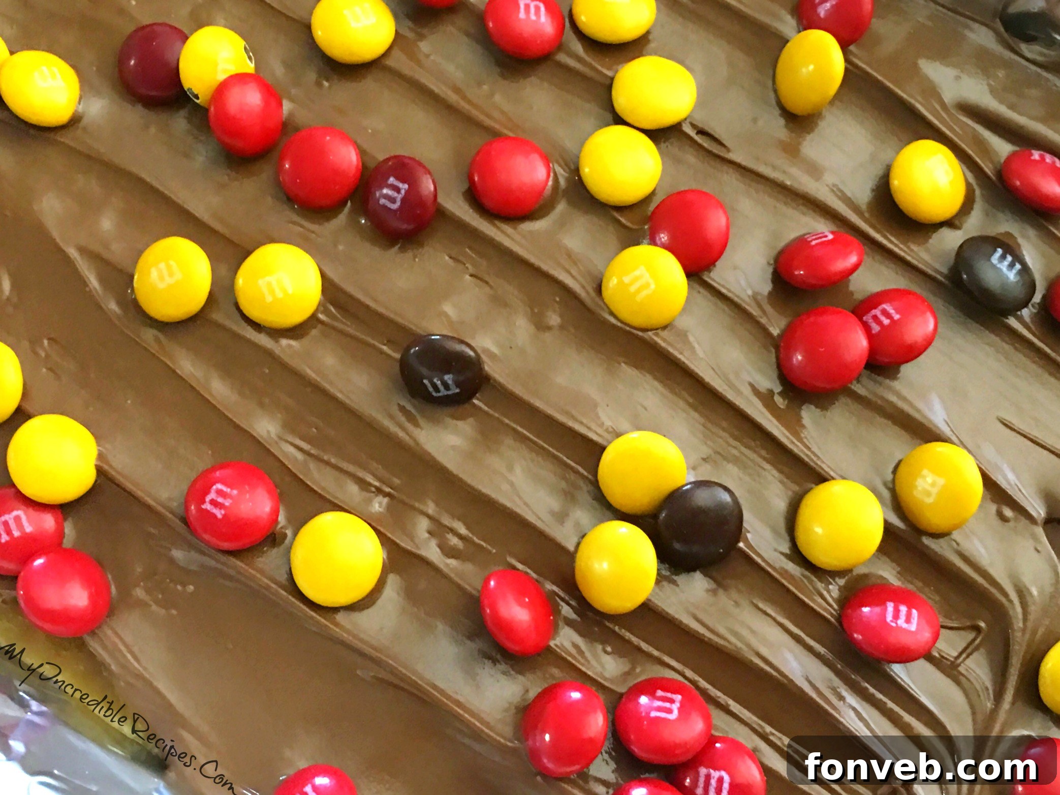 Overhead view of a tray of saltine cracker toffee with M&Ms
