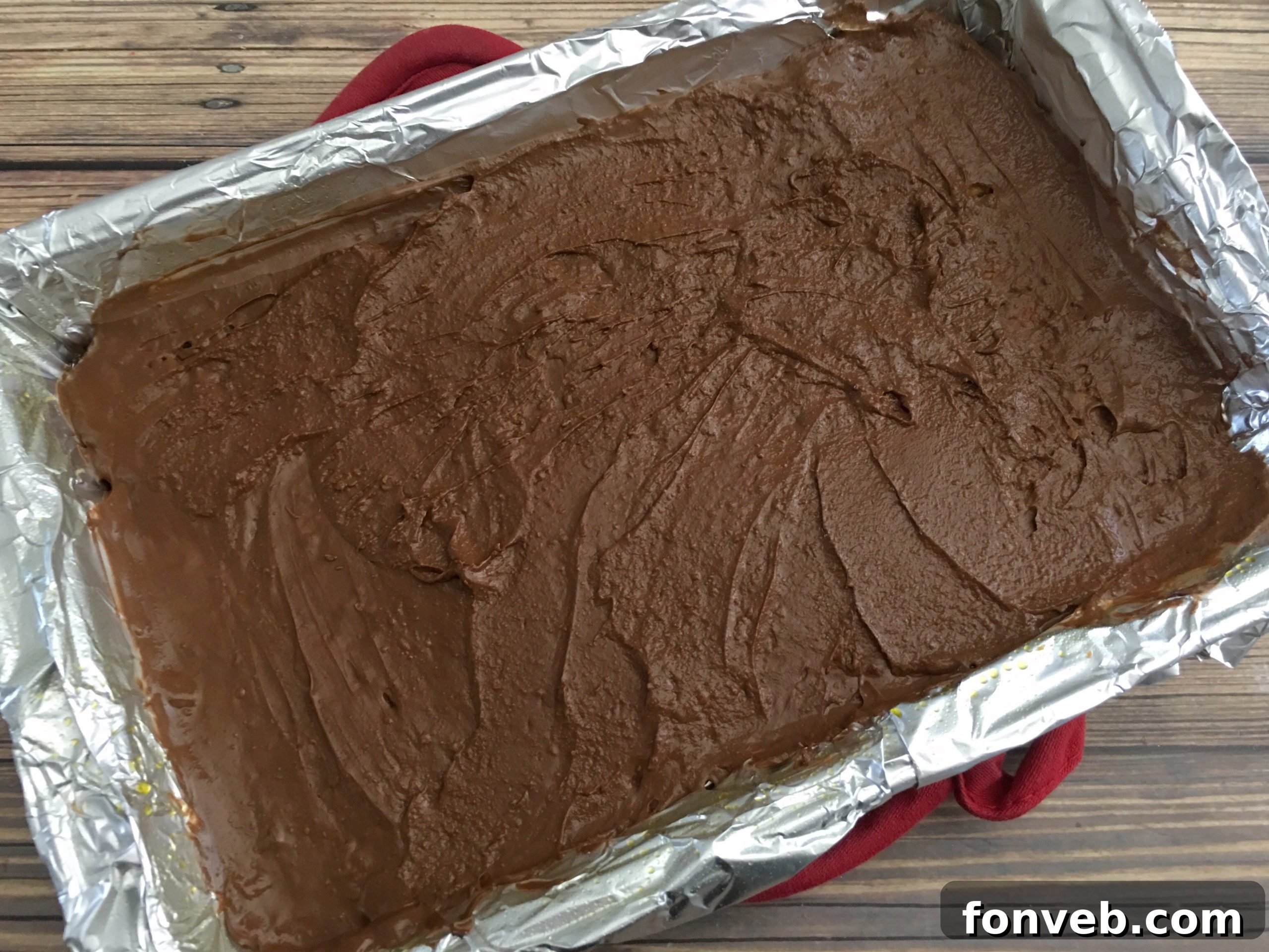 Melted chocolate spread smoothly over the toffee and cracker base