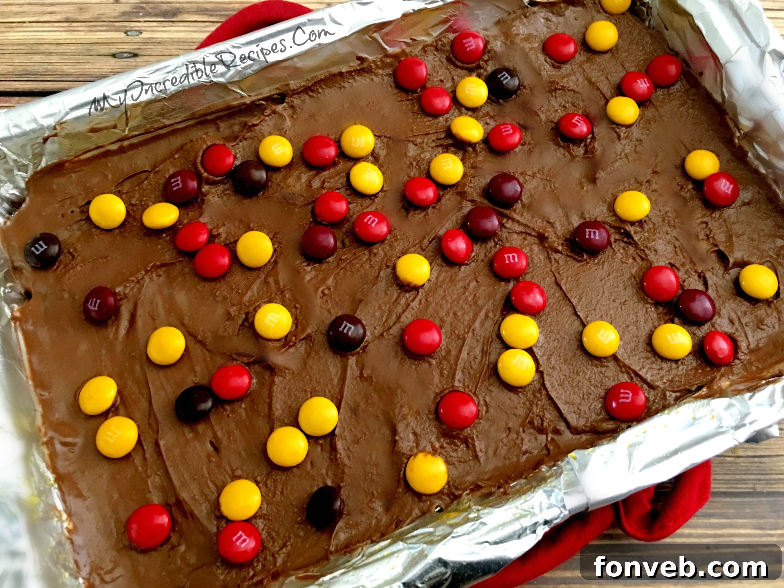 Melted chocolate spread over toffee crackers, topped with colorful M&Ms