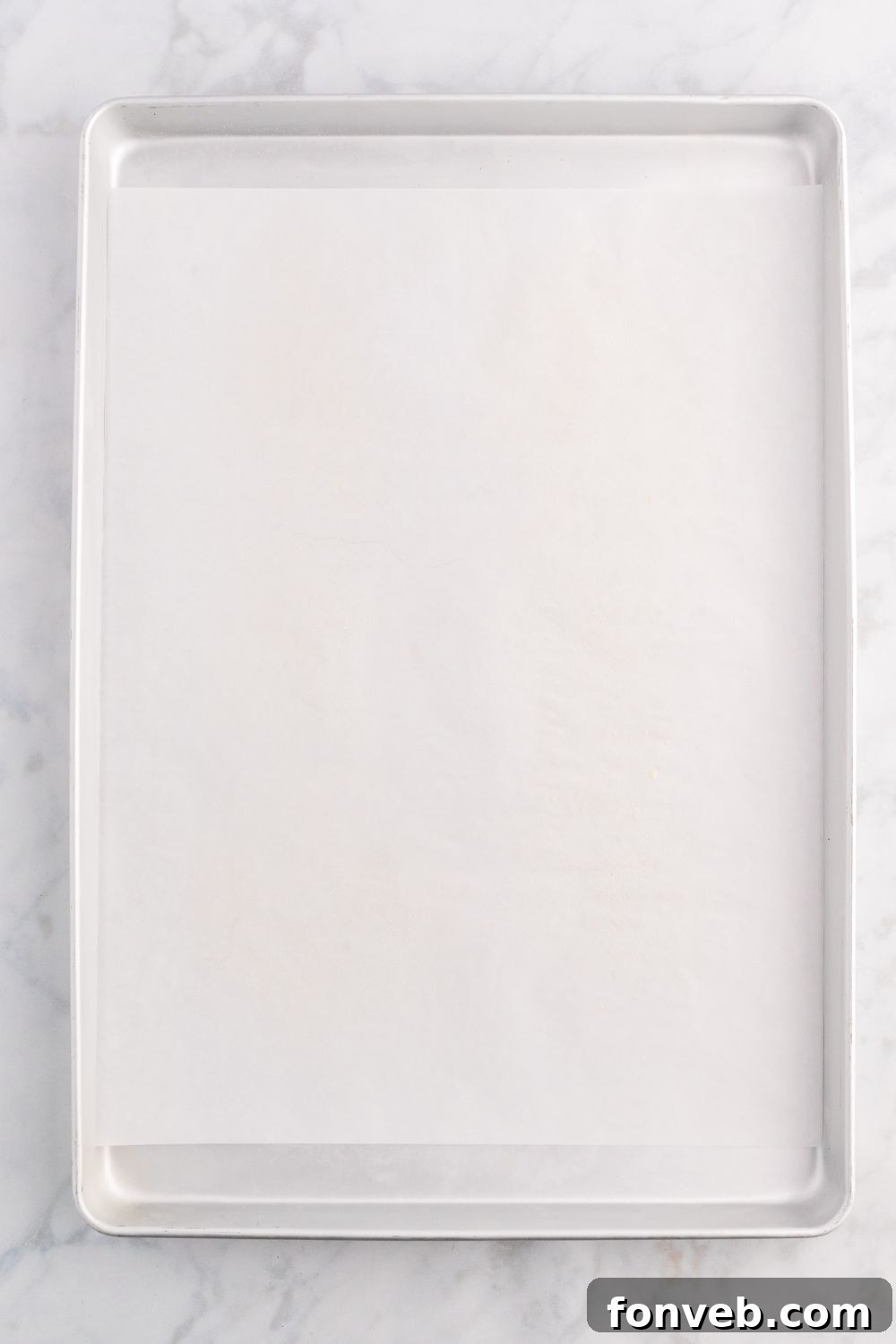 sheet pan with parchment paper on it 