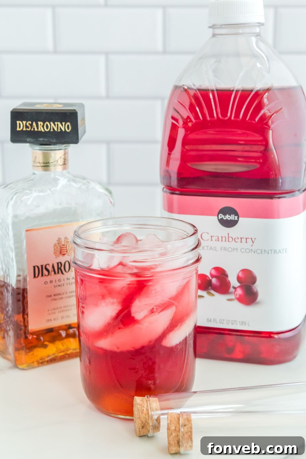 cranberry juice poured on top of disaronno in jar