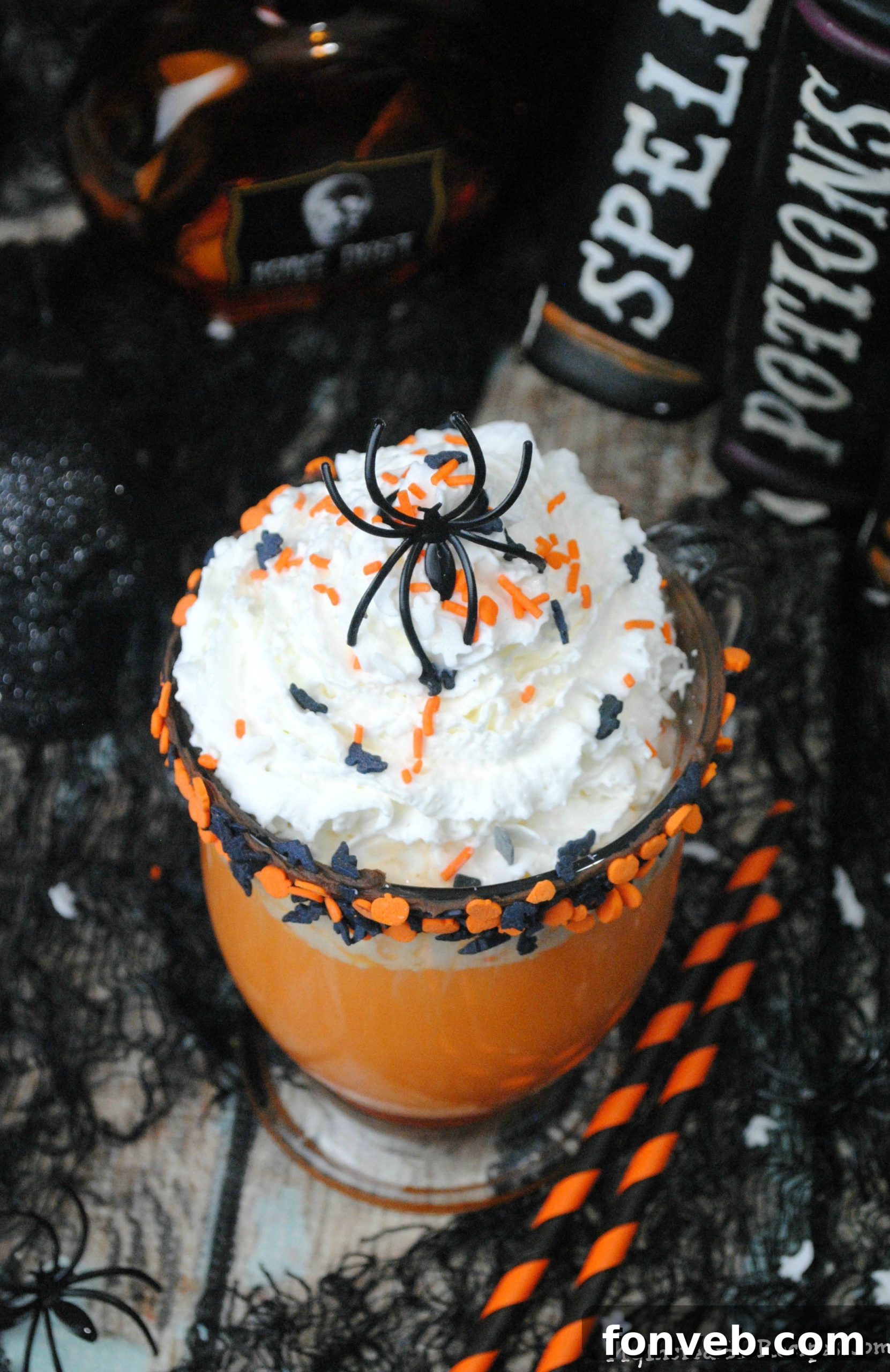 Vibrant orange Halloween hot chocolate being poured into a mug