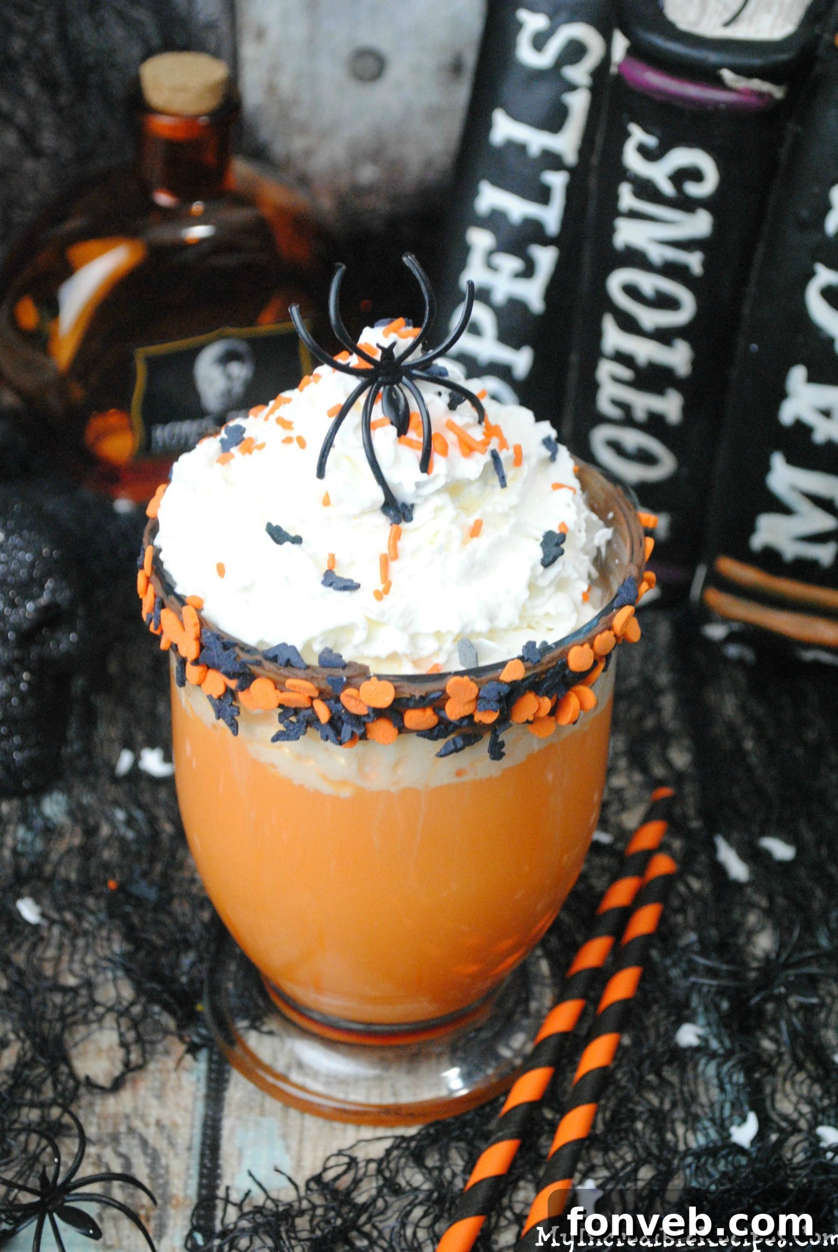Mugs of Halloween hot chocolate with festive garnishes displayed on a cozy fall background