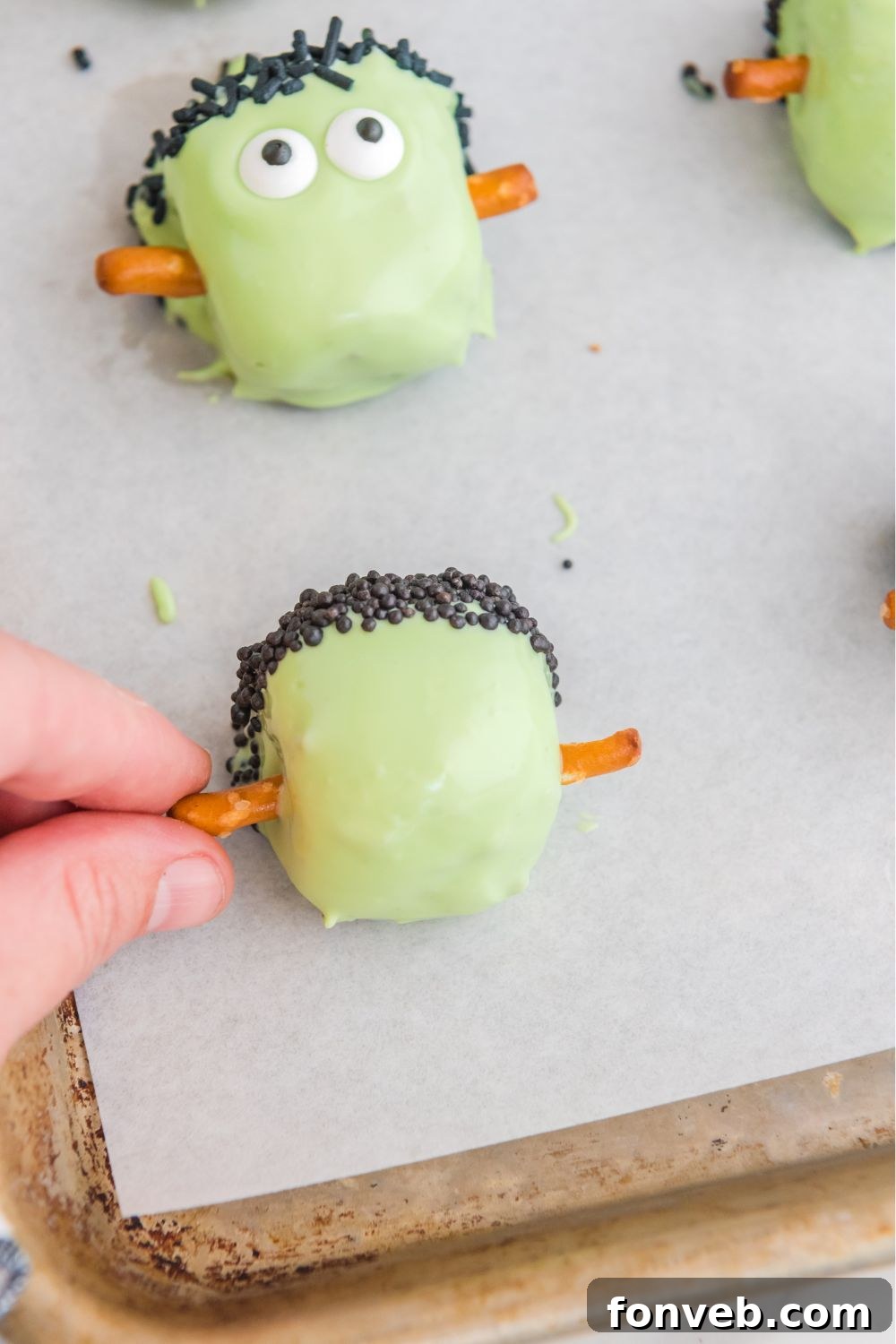 FrankenOreo Bites 11 sticking pretzels into the sides of the truffles