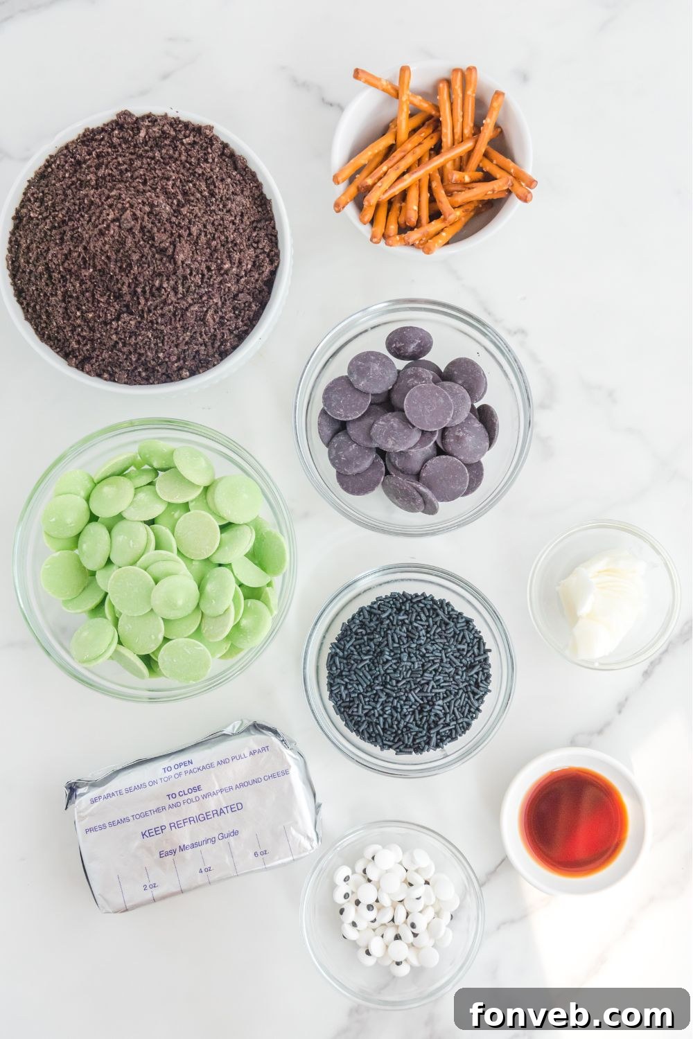 FrankenOreo Bites 4 Frankenstein Oreo Balls ingredients on glass containers on a marble counter