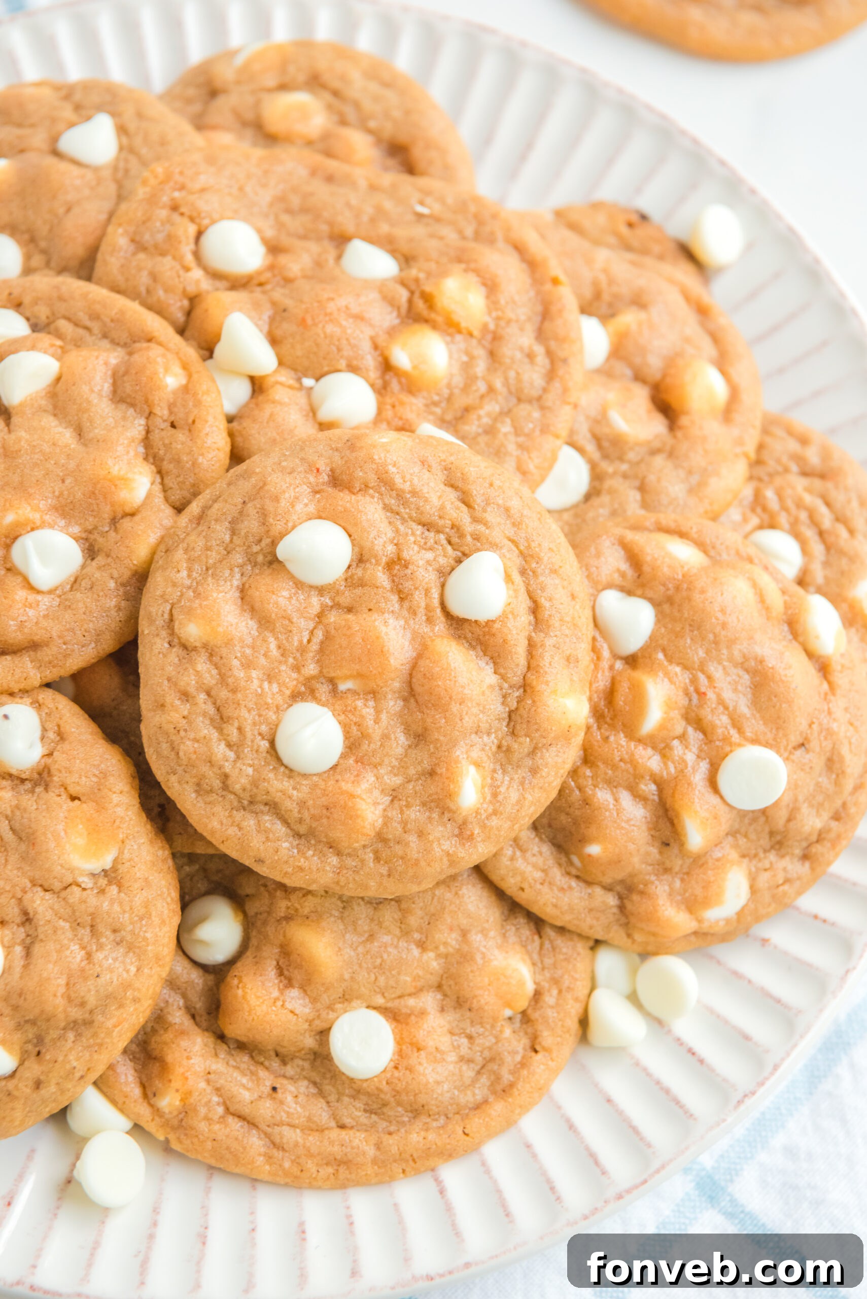up close angle of a pile of Pumpkin Spice Pudding Cookies on a white plate
