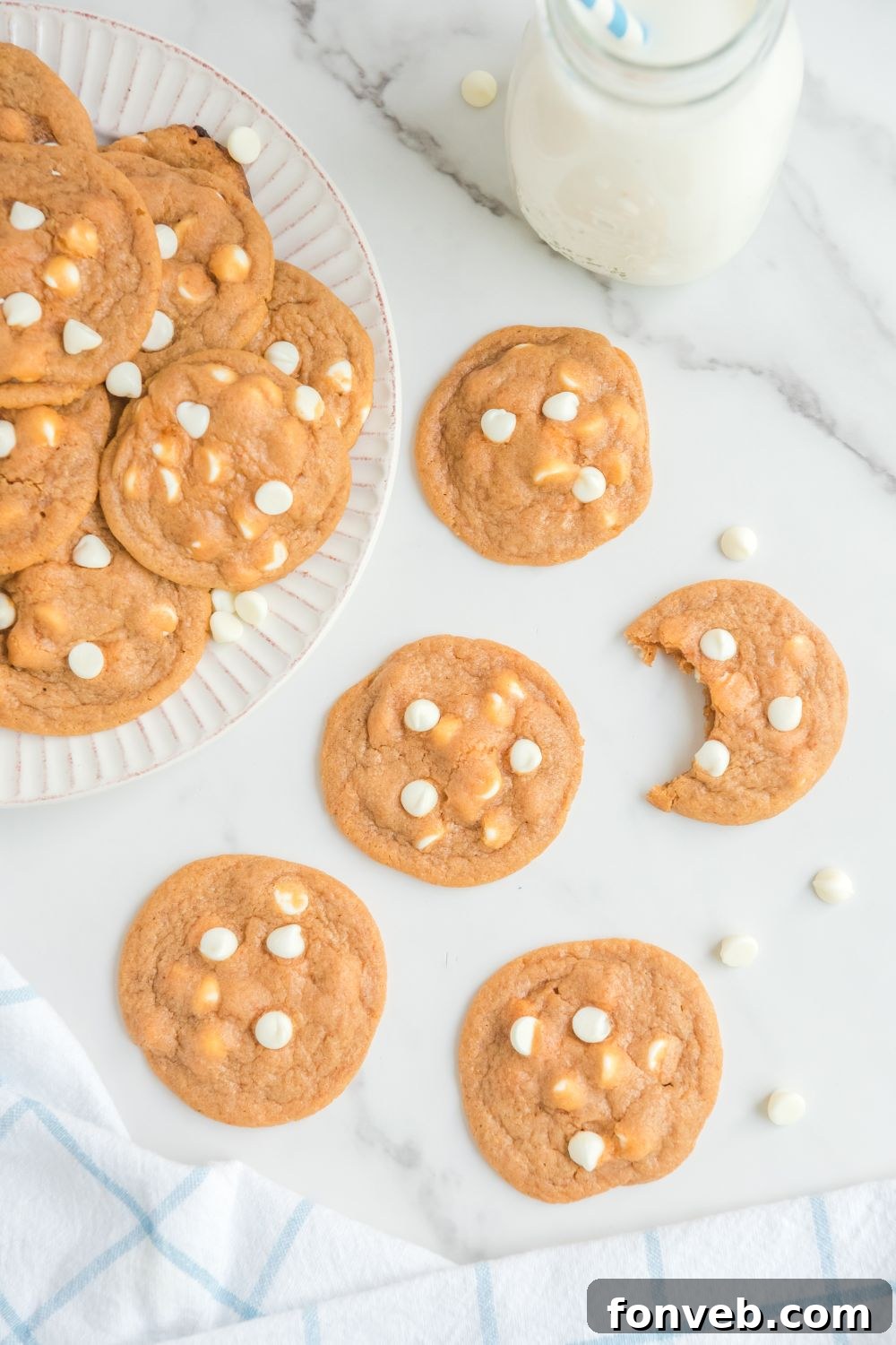 cookies on table with one cookie with a bite taken out