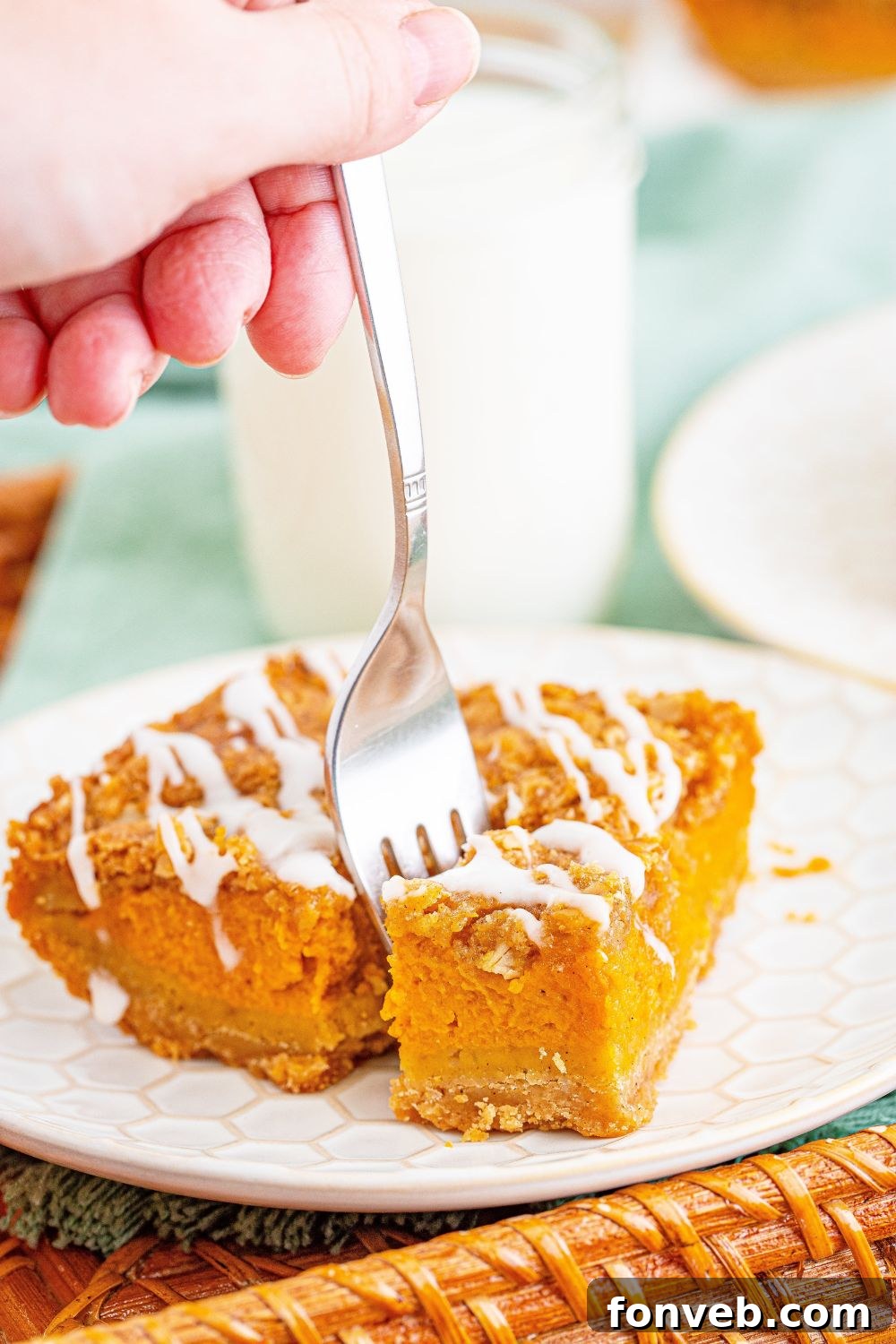 fork poking into a sliced pumpkin streusel bar