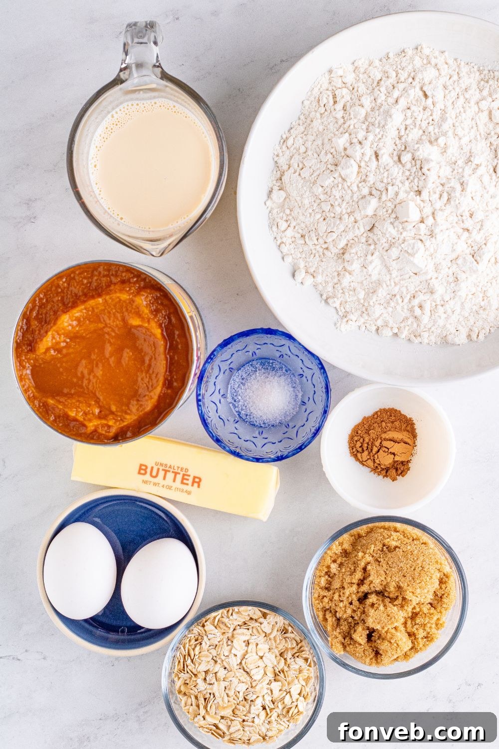 pumpkin dessert with all ingredients in bowl sitting on marble counter