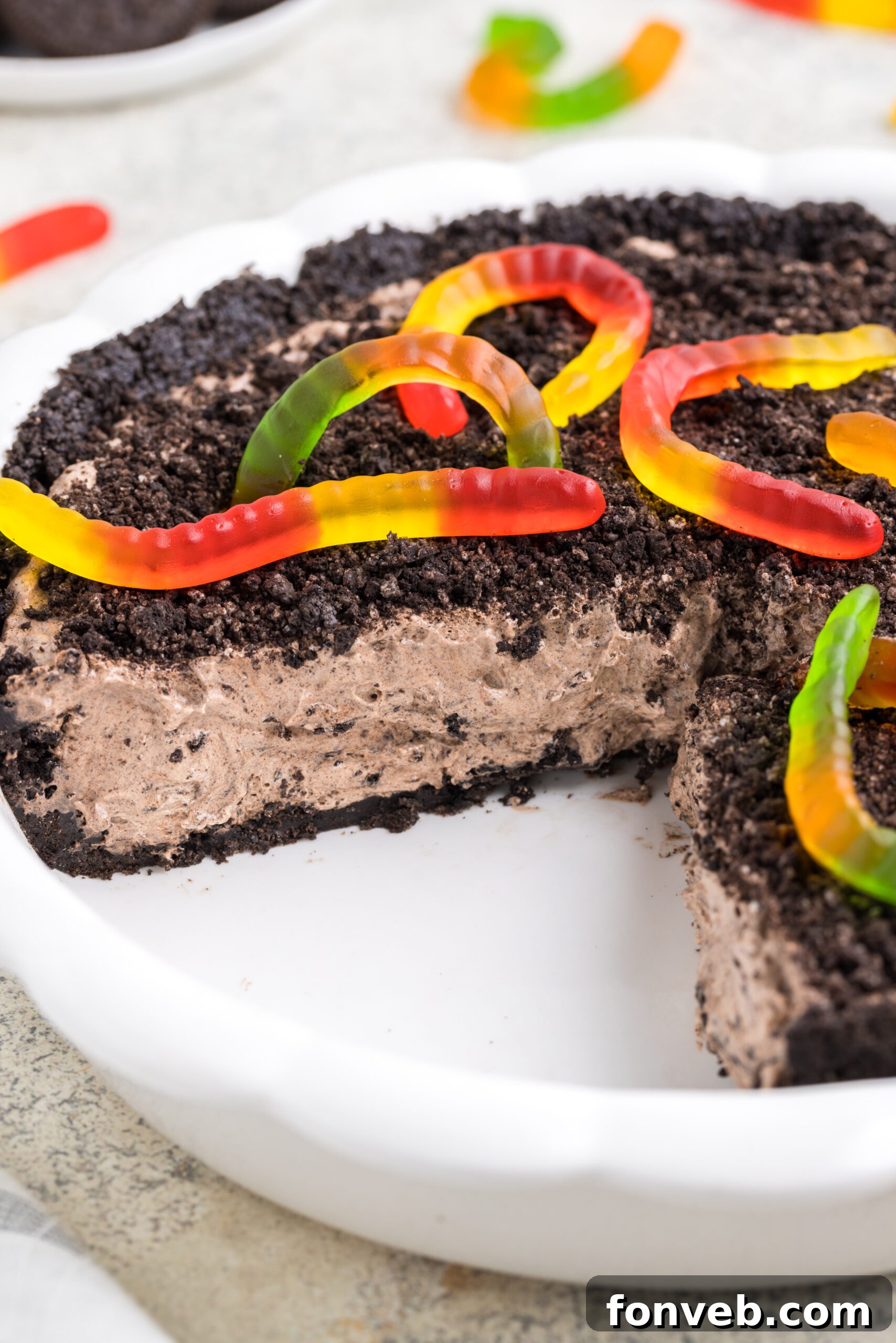 dirt pie in a white baking pan with a few slices cut out