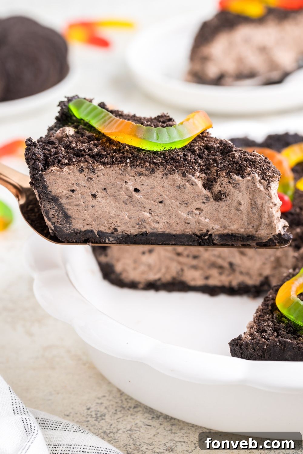 oreo dirt pie slice being lifted up by a spatula