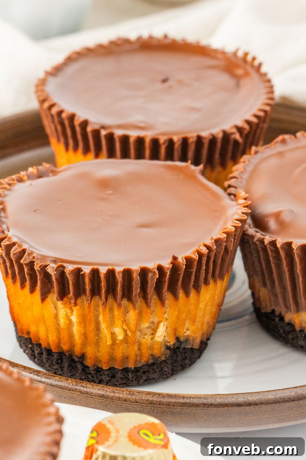 Several cheesecake cups presented on plates on a table, ready to be served.