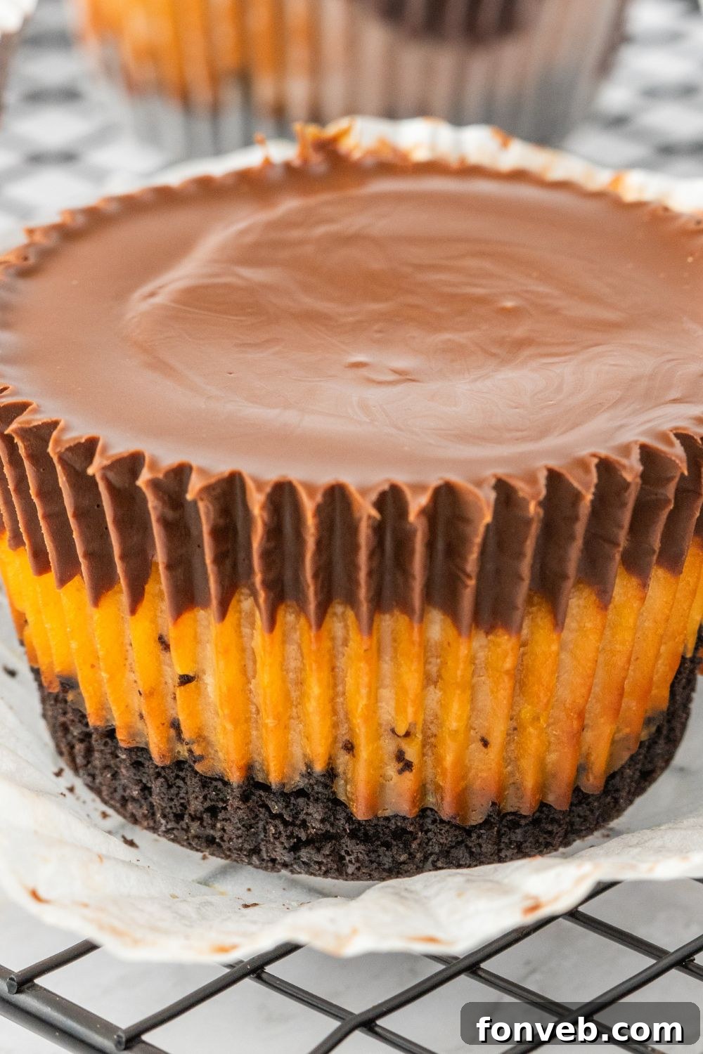 A single peanut butter cheesecake bite removed from its liner, sitting on a tray.