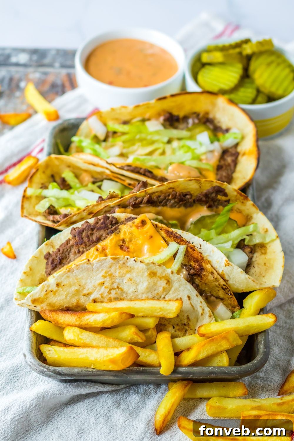 Smashed Big Mac Tacos 14 A plate featuring Big Mac smash tacos surrounded by golden french fries