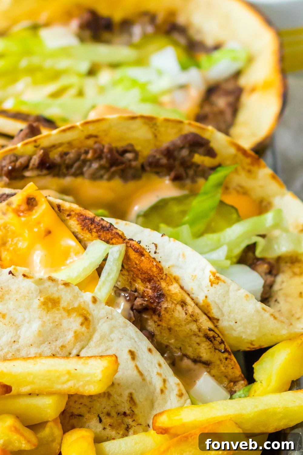 Smashed Big Mac Tacos 16 A platter with Big Mac tacos and crispy french fries on a metal tray, perfect for sharing