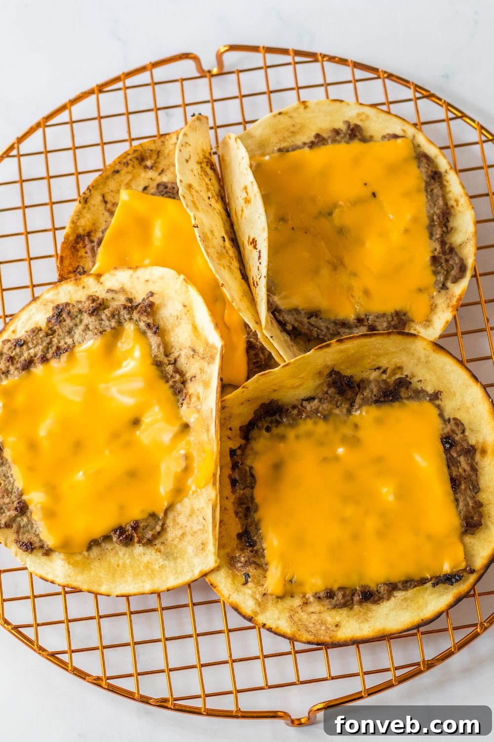 Smashed Big Mac Tacos 8 Smash taco burgers with melting American cheese on top, ready for final assembly