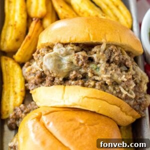 Slow Cooker French Dip Sandwiches on tray with fries behind it