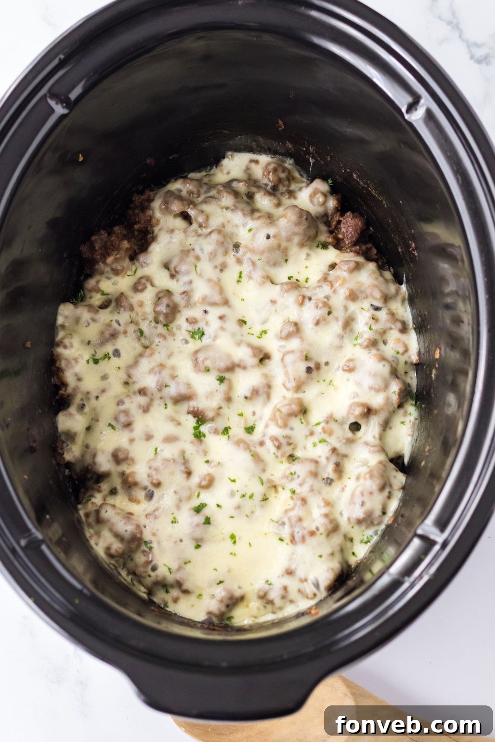 cheese melted on top of meat mixture in slow cooker 
