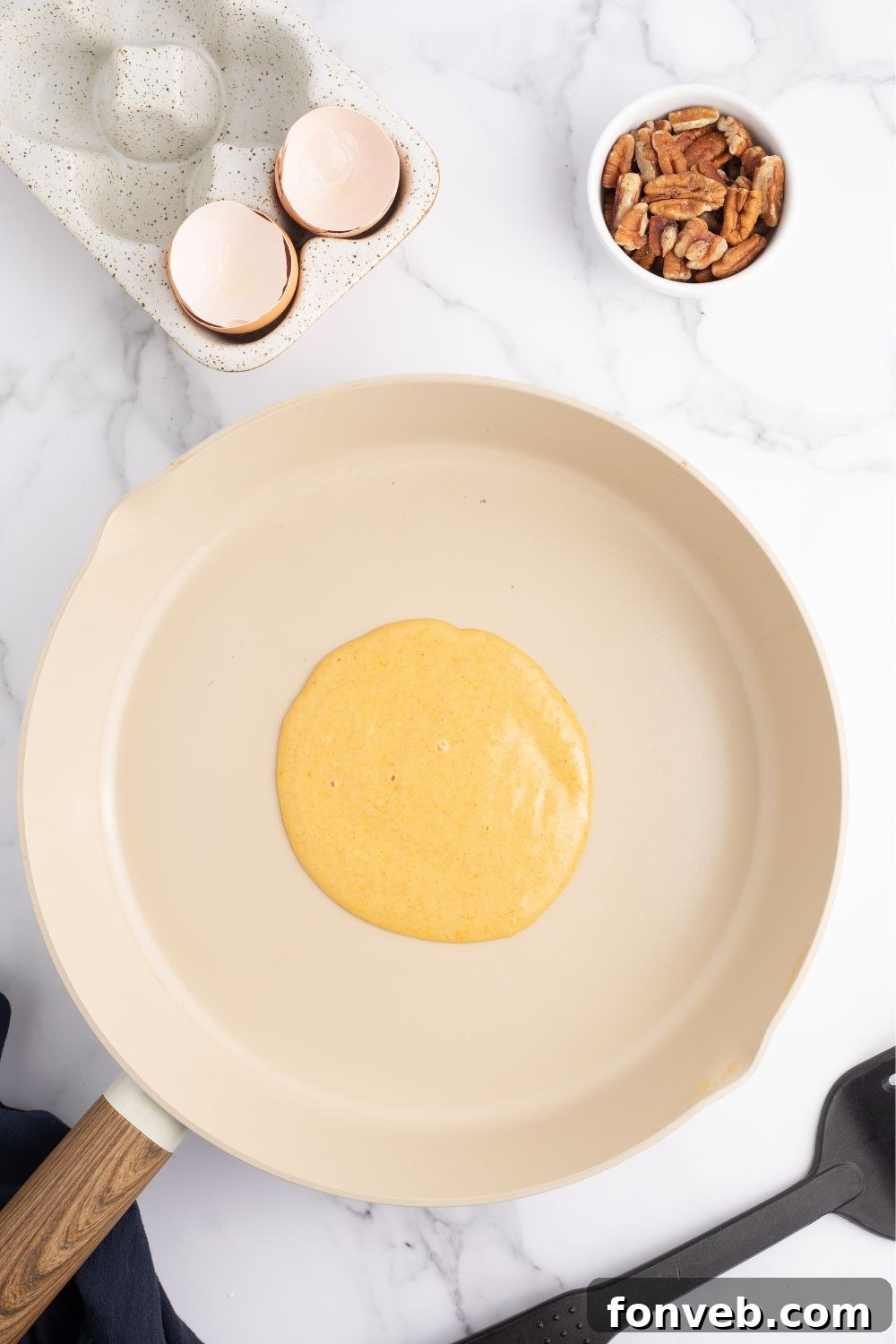 raw pancake batter in a skillet