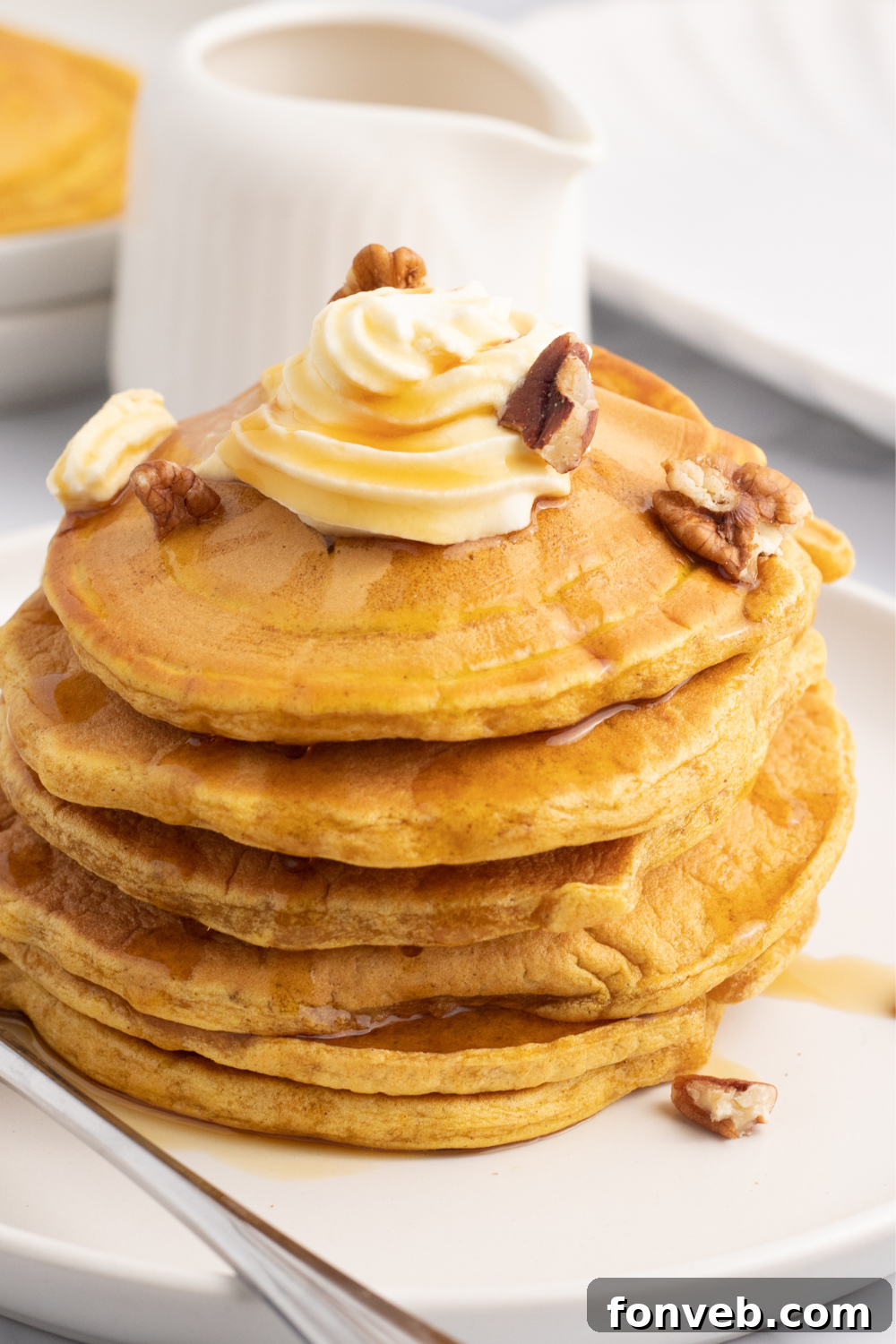 pumpkin pancakes stacked on plate