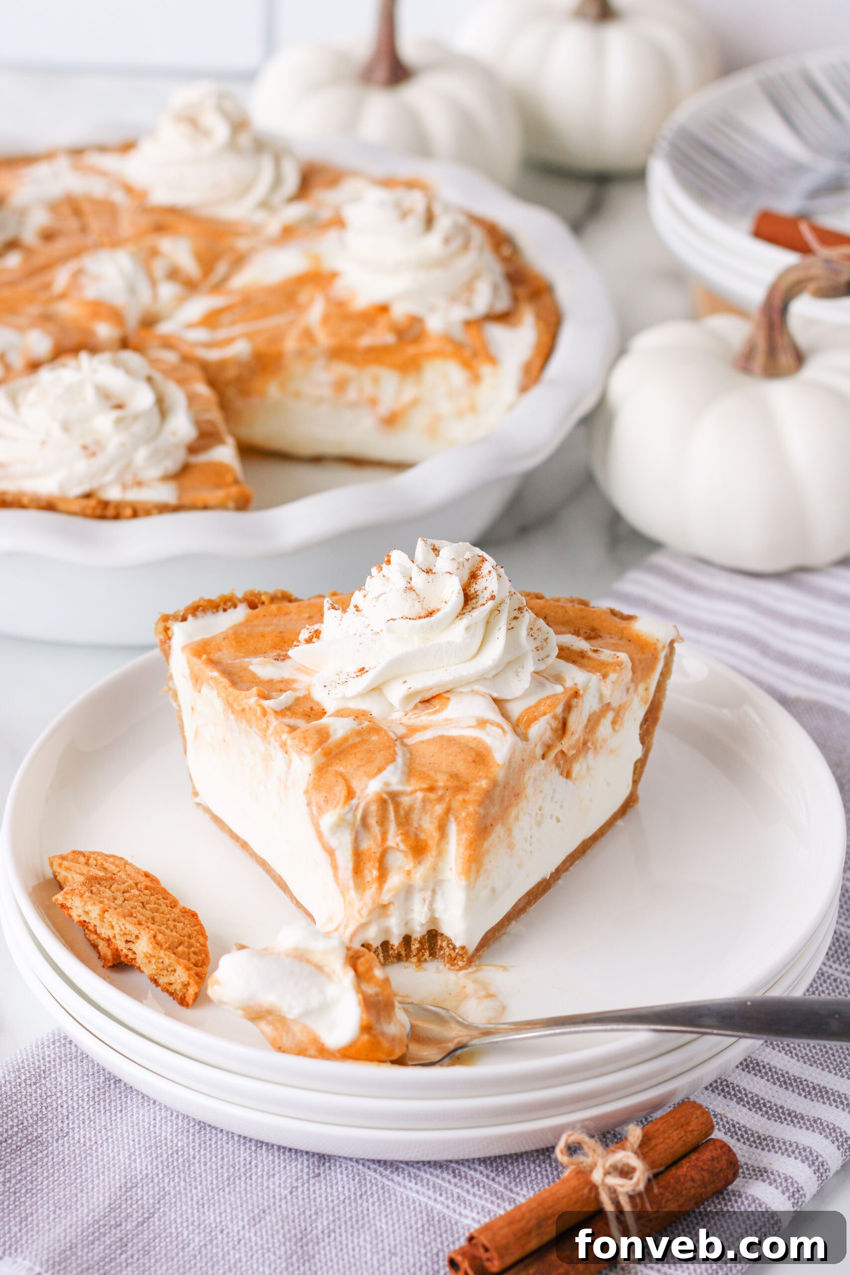 Spiced Pumpkin Ice Cream Pie 20 Pumpkin Ice Cream Pie slice on a white plate with a bite missing