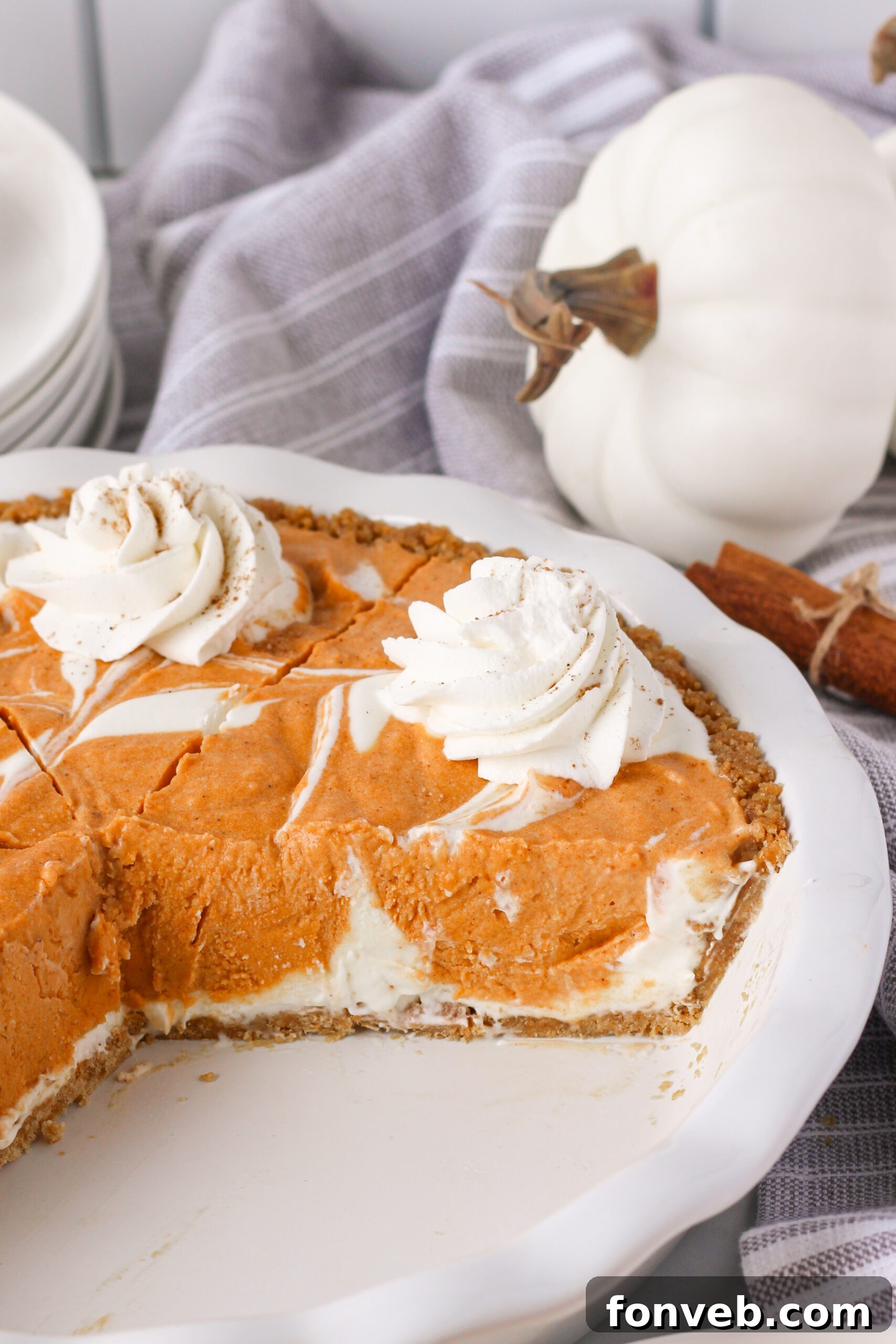 Spiced Pumpkin Ice Cream Pie 24 Pumpkin Ice Cream Pie in a white baking dish with a couple of slices missing