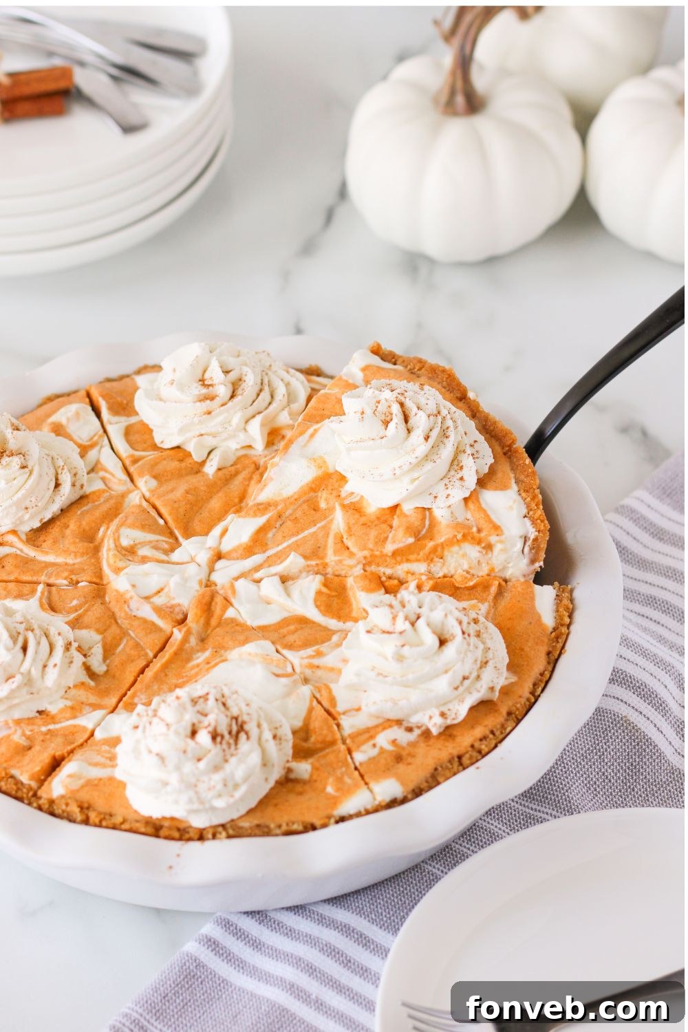 Spiced Pumpkin Ice Cream Pie 25 pumpkin pie ice cream cake in a pan with a spatula in one side to lift slice out