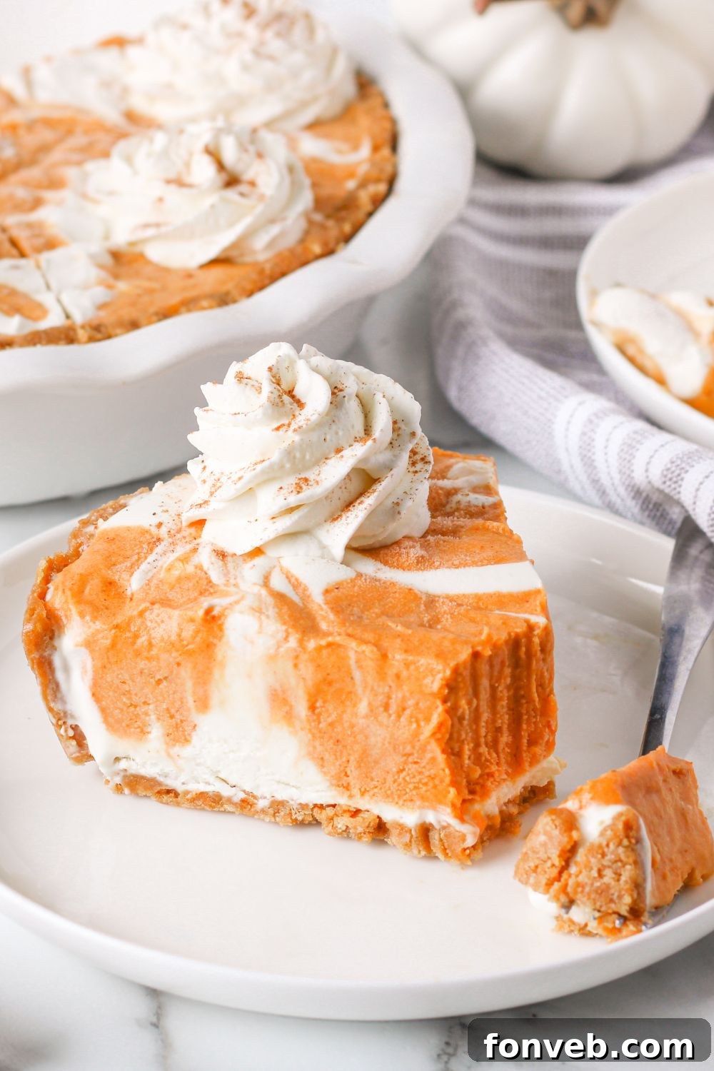 Spiced Pumpkin Ice Cream Pie 5 slice of pumpkin ice cream pie on plate with bite taken out of it