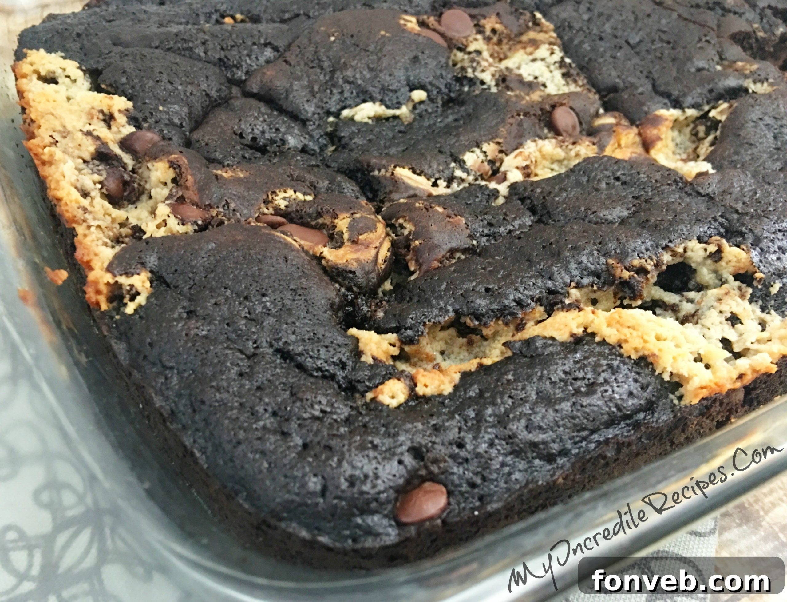 A side view of the freshly baked Peanut Butter Earthquake Cake, showing its height and a rich, golden-brown crust