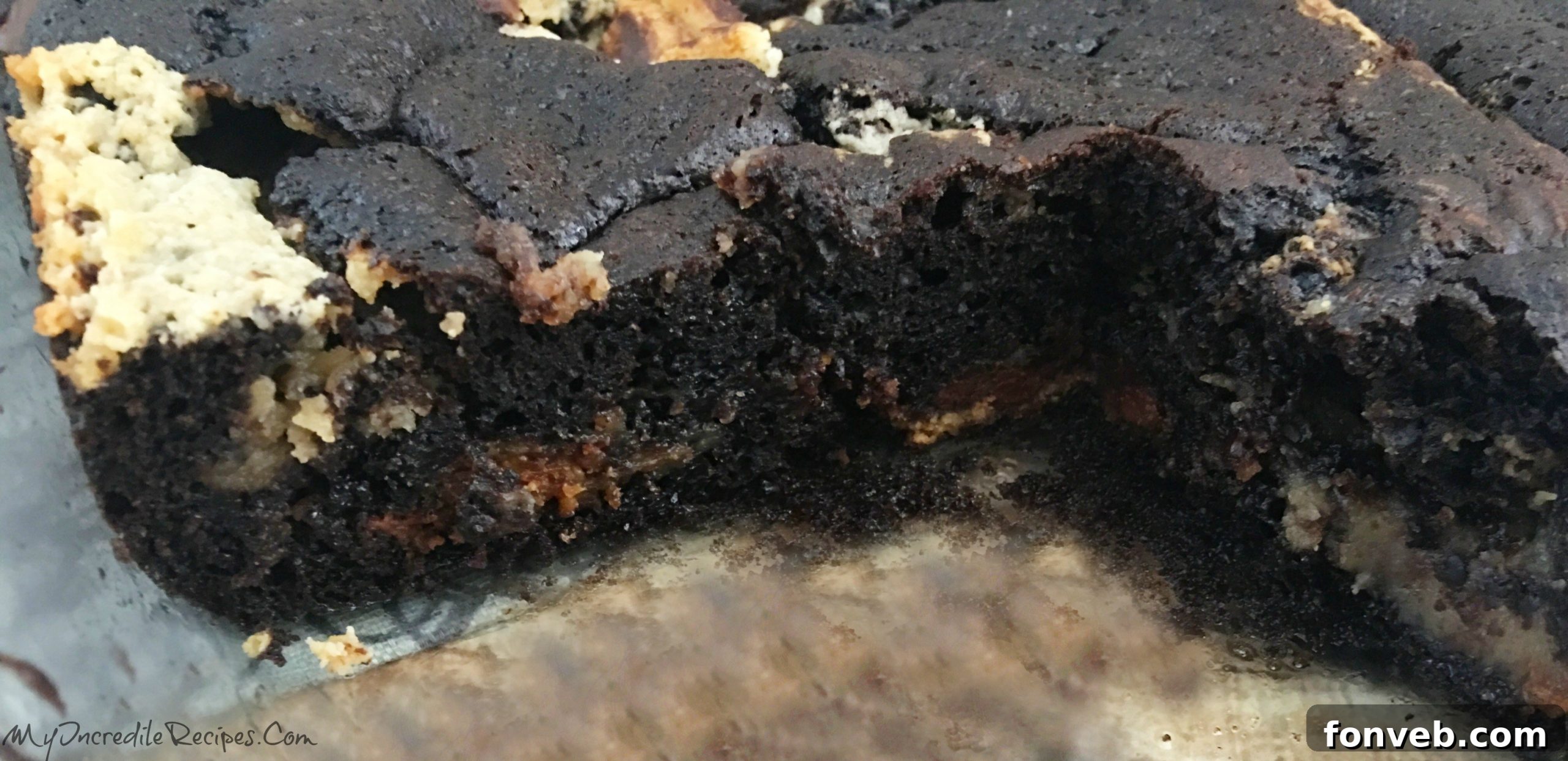 A top-down shot of the cake, showing the deep crevices and gooey centers where the fillings have settled