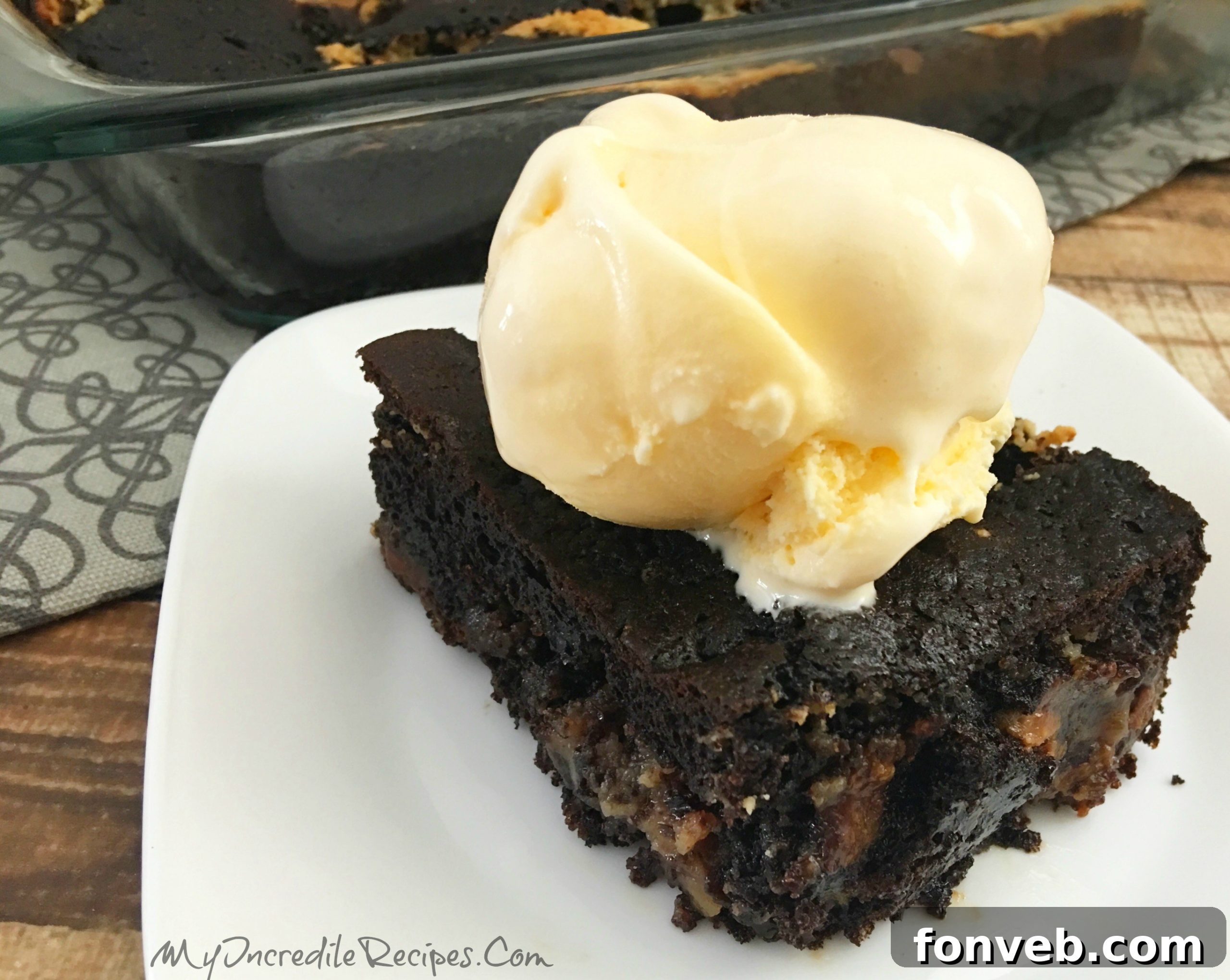 Close-up of a fork digging into a slice of Peanut Butter Earthquake Cake with melted ice cream