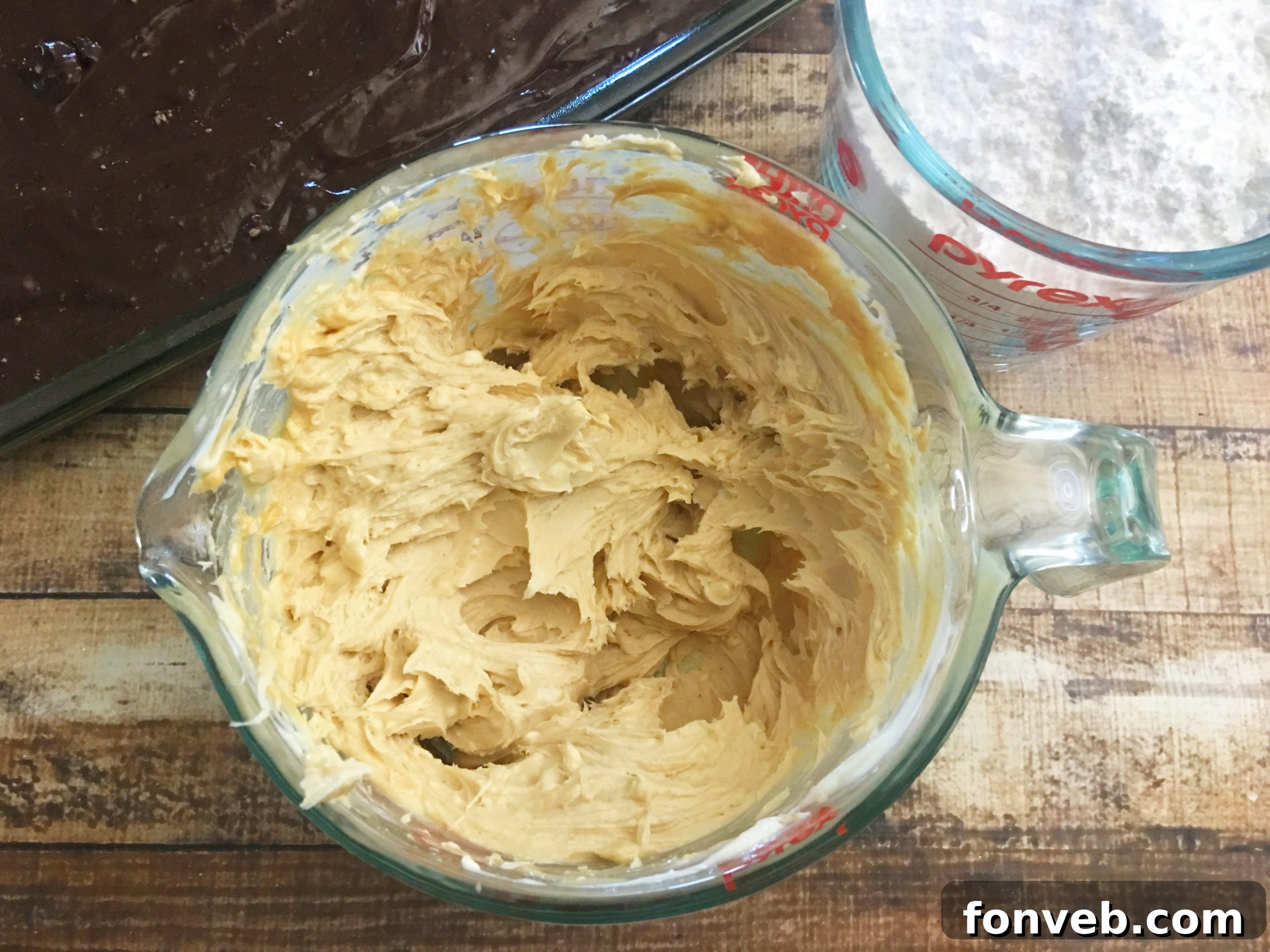 Close-up of the creamy peanut butter and softened cream cheese mixture being prepared