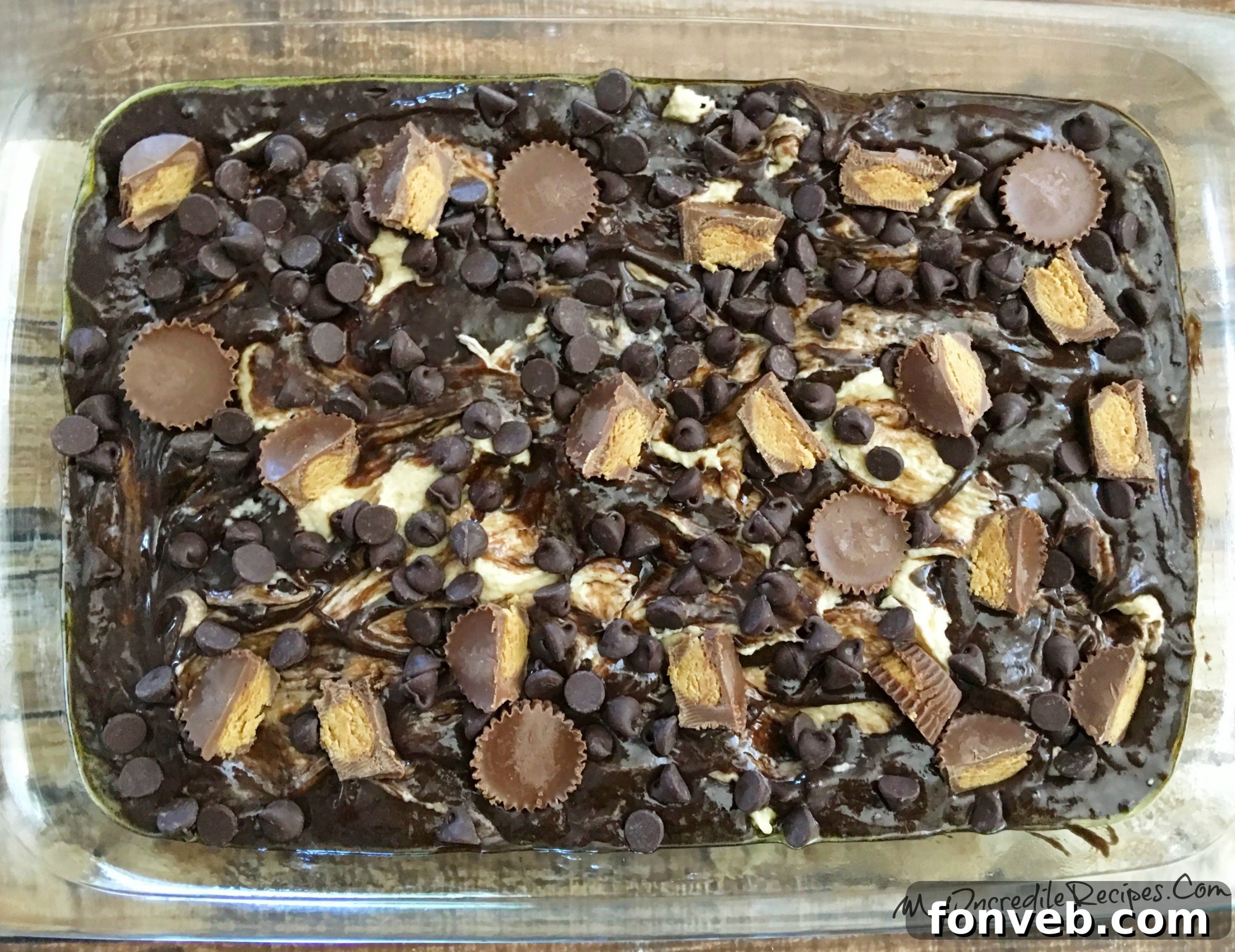 Another angle of the unbaked cake, showing the generous distribution of Reese's Peanut Butter Cups and chocolate chips