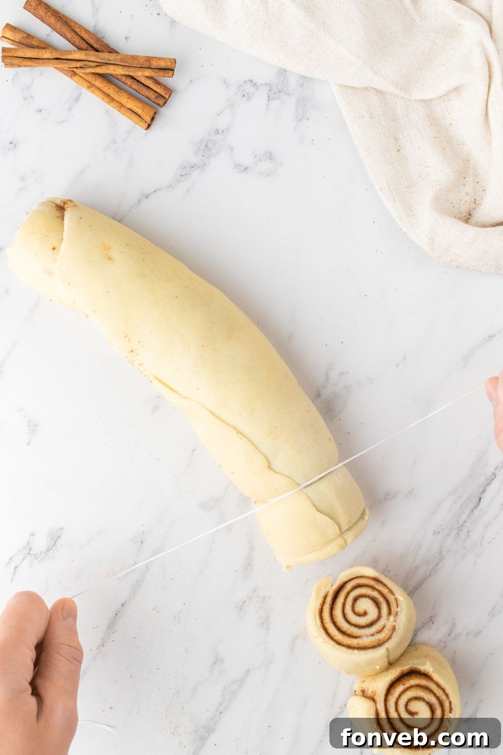 slicing cinnamon rolls on marble counter 