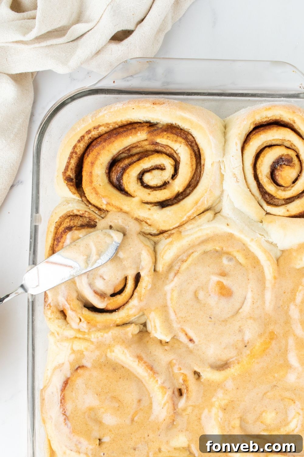 spreading frosting on cinnamon rolls 