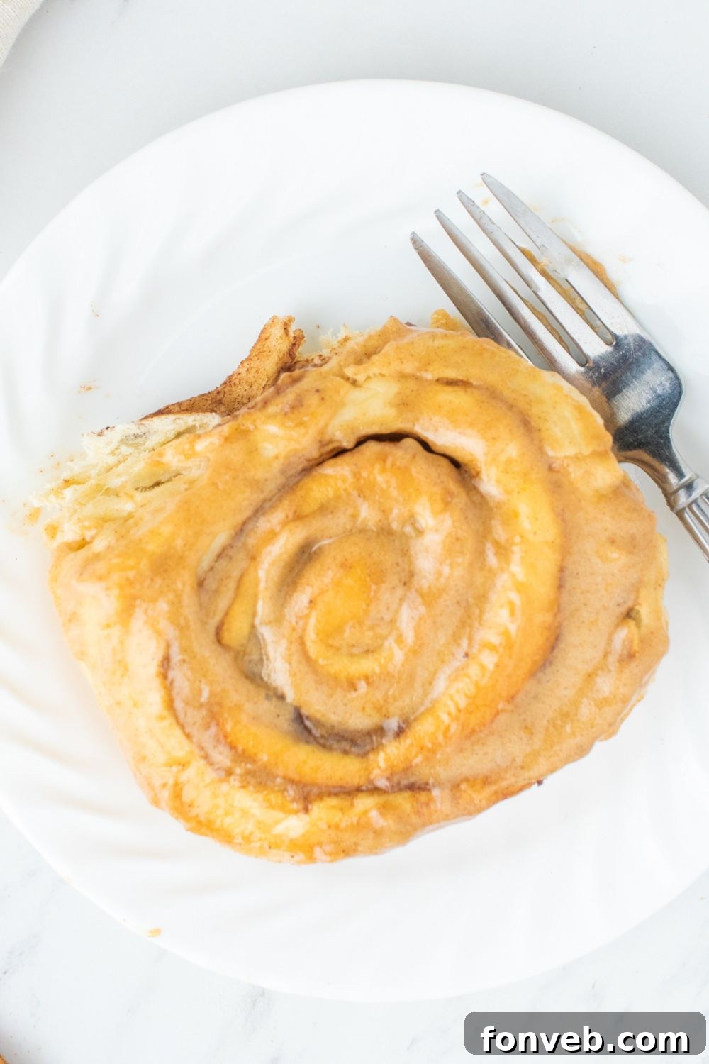 overhead shot of cinnamon roll on plate on table