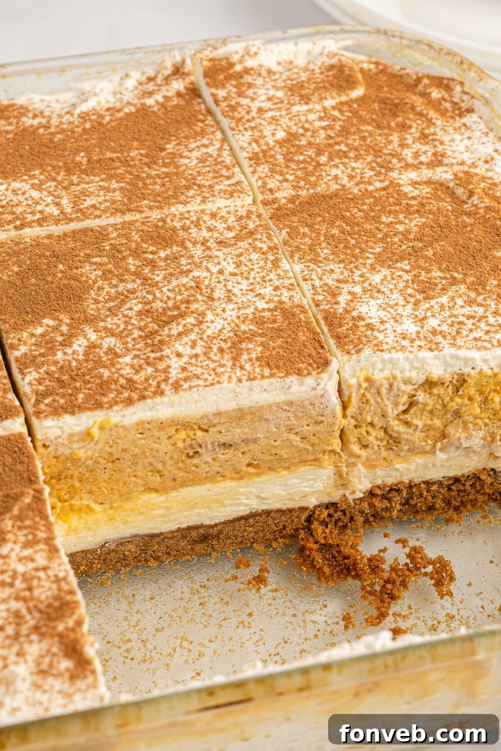 A baking pan of Pumpkin Delight with a few squares already removed, showcasing the neat cuts and layers.