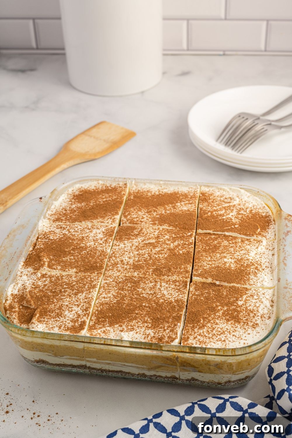 The full pan of pumpkin dream delight resting on a kitchen counter, ready for final chilling.