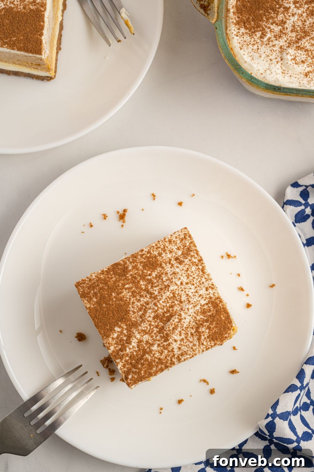 A beautifully presented slice of Pumpkin Delight on a white plate with a fork beside it, ready to be enjoyed.
