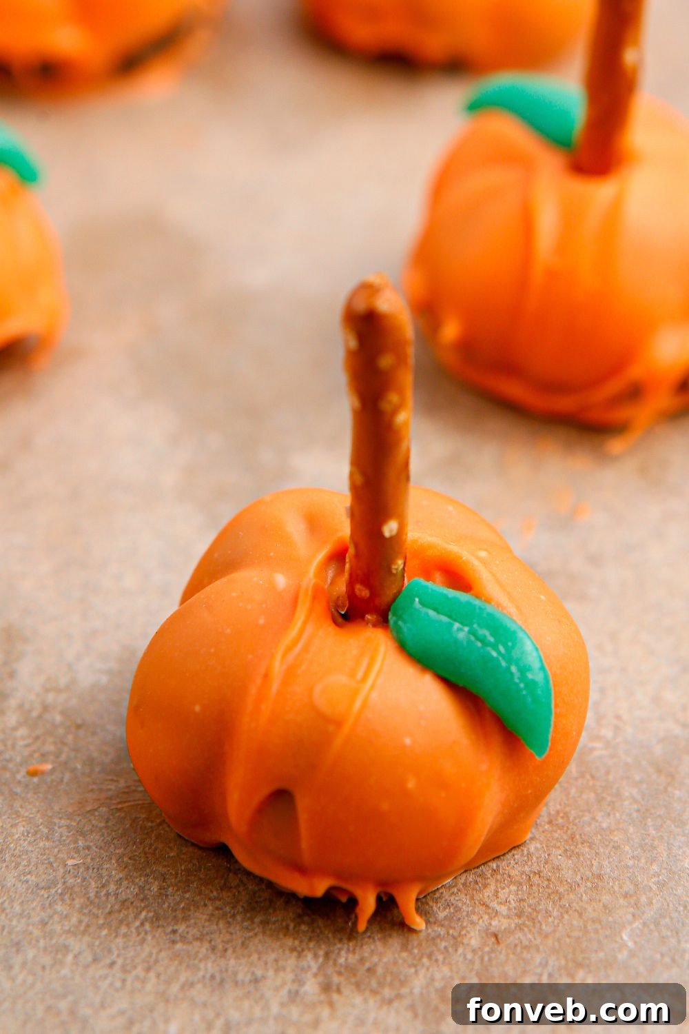 Pumpkin Spiced Oreo Truffles 12 close up of Oreo ball truffle on parchment paper