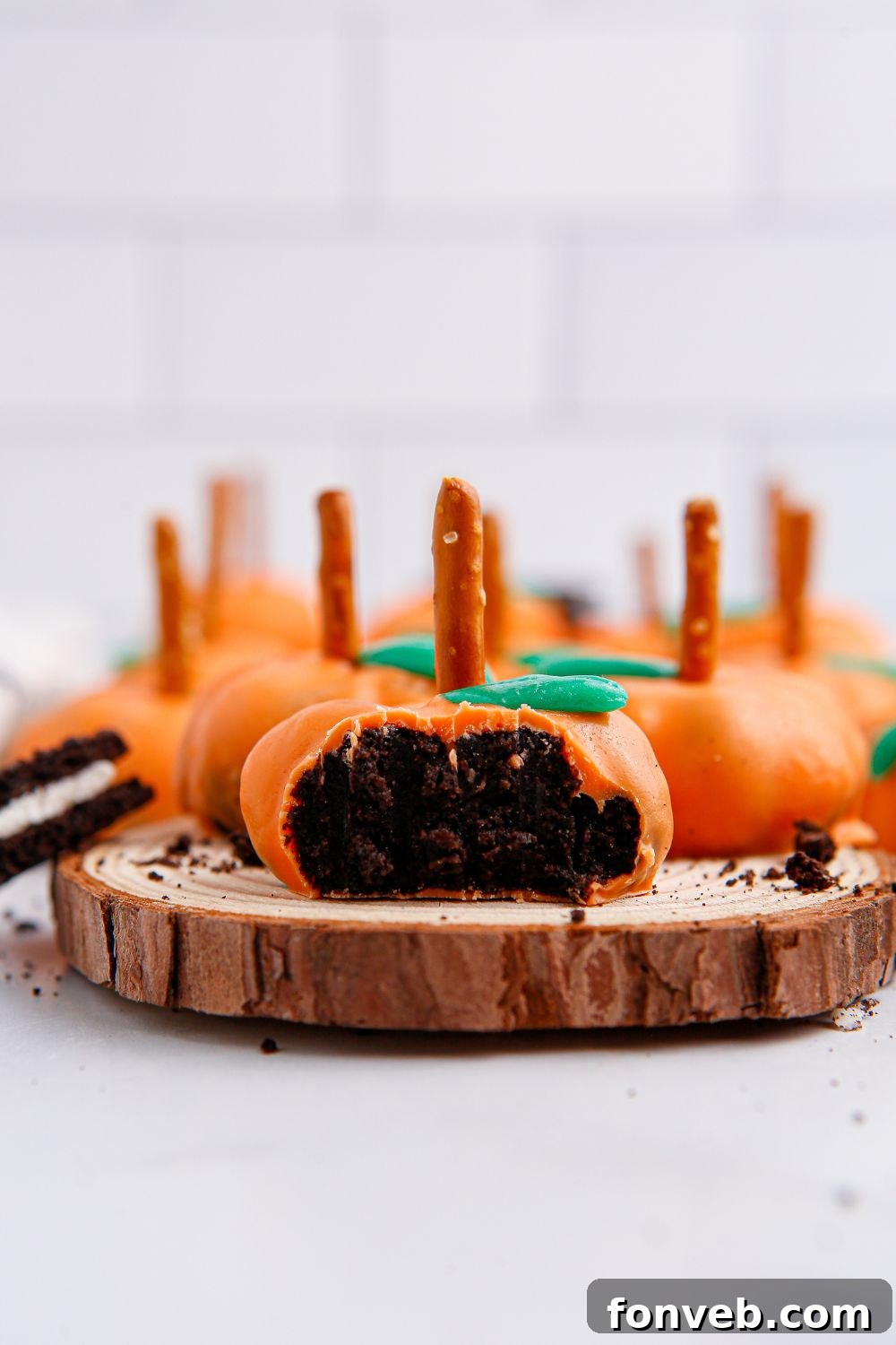 Pumpkin Spiced Oreo Truffles 15 pumpkin oreo balls on a wooden cutting board on table
