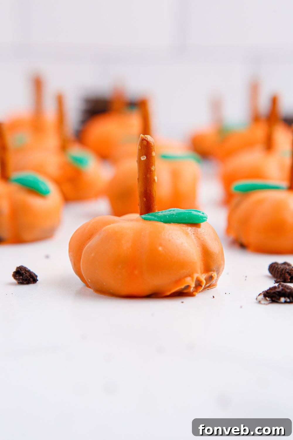 Pumpkin Spiced Oreo Truffles 19 pumpkin shaped oreo treats on white table