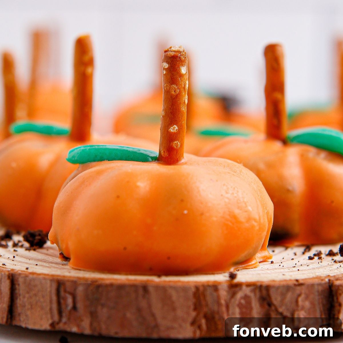 Pumpkin Spiced Oreo Truffles 3 Pumpkin Oreo Balls on wooden tray