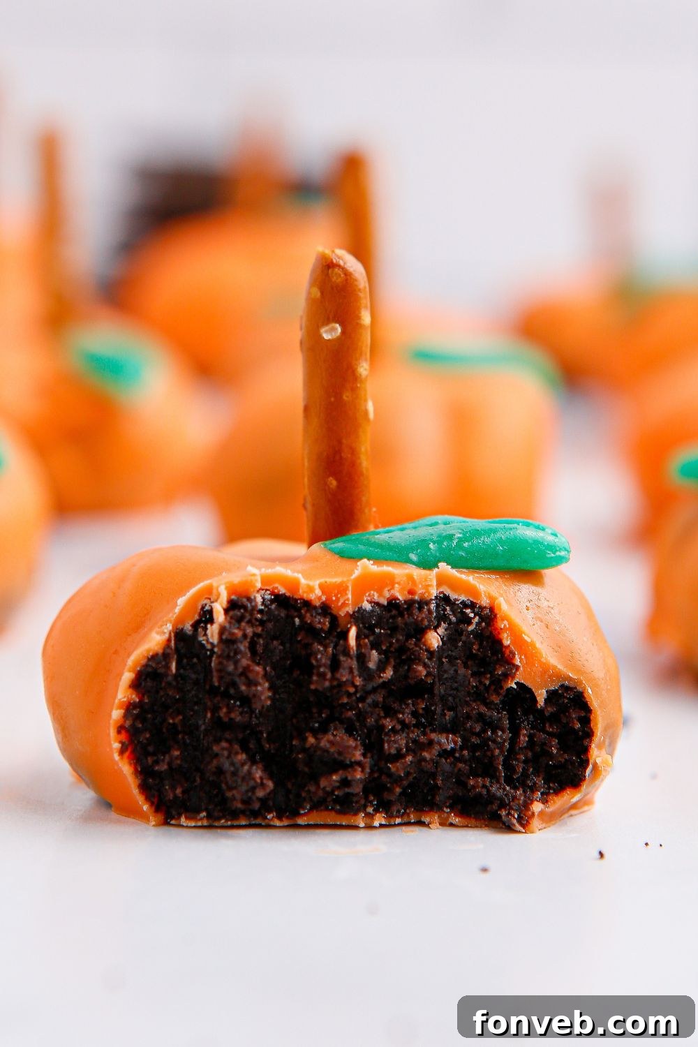Pumpkin Spiced Oreo Truffles 4 oreo ball shaped like pumpkin with bite taken out