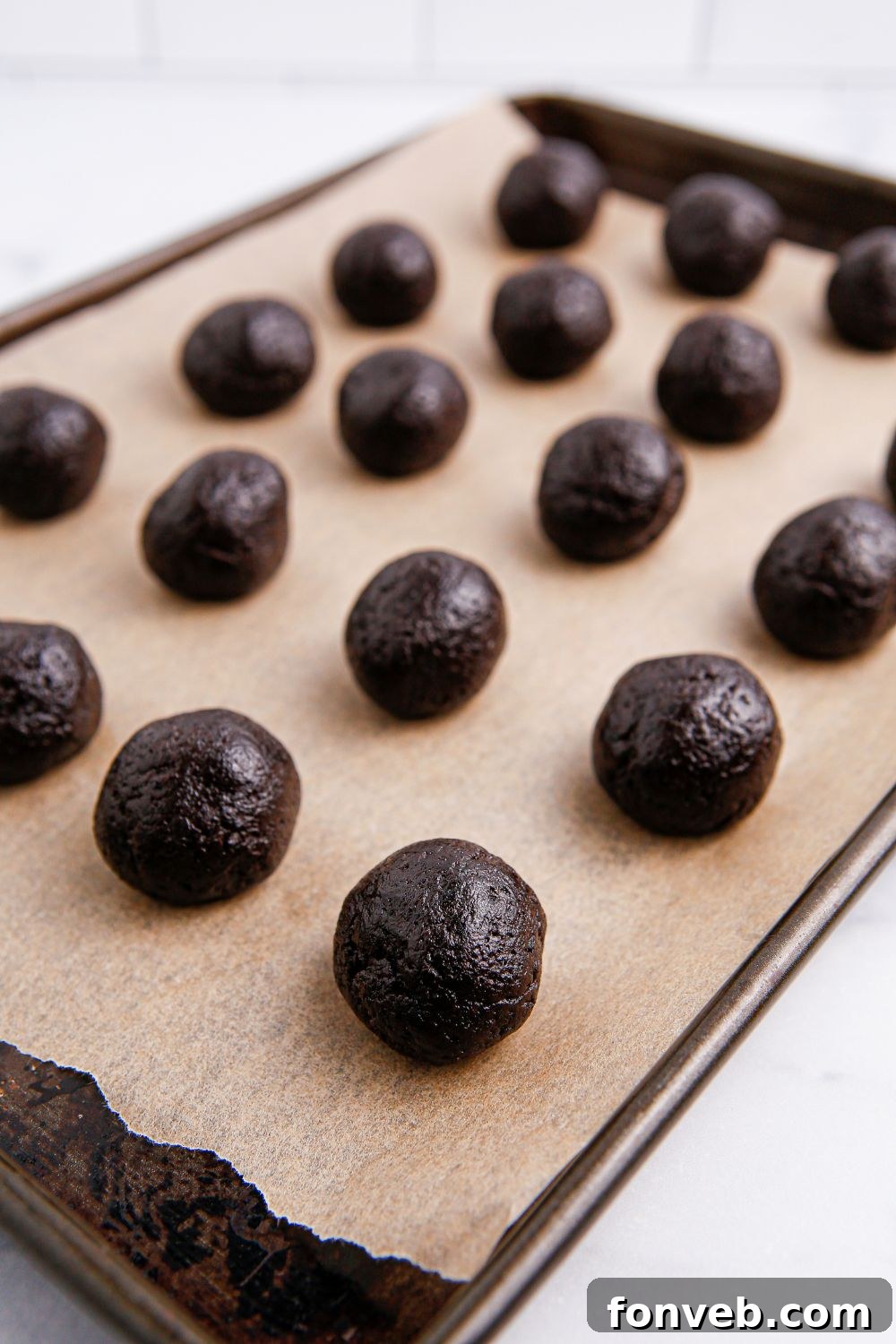 Pumpkin Spiced Oreo Truffles 9 round oreo balls on a cookie tray