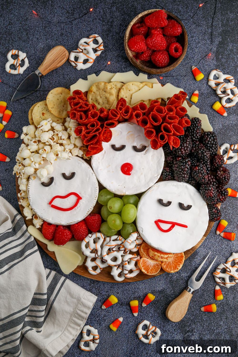 A full Hocus Pocus themed dinner spread, showcasing the charcuterie board as the main attraction alongside other Halloween-inspired dishes, creating a complete festive meal.