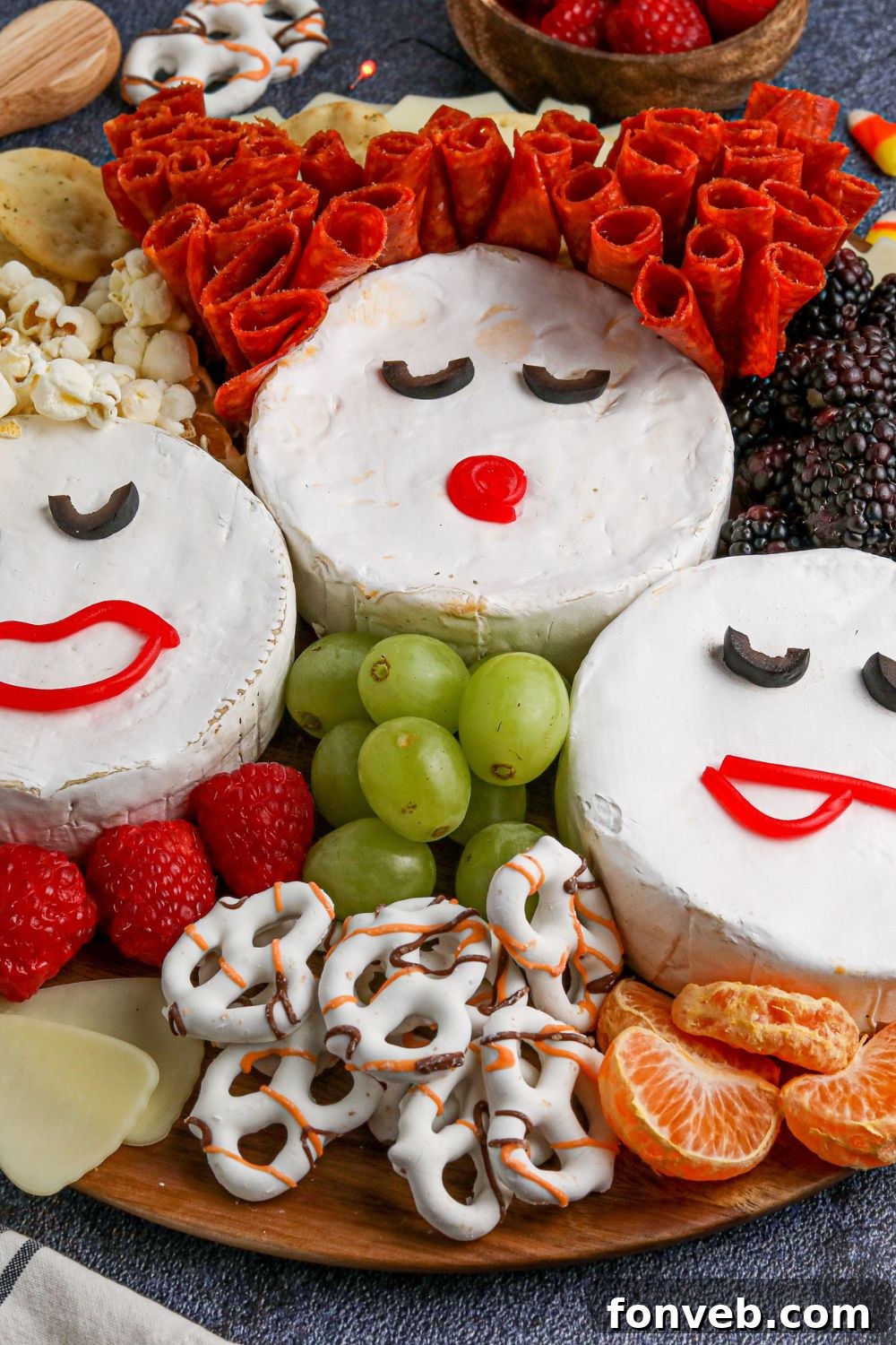 A charming Halloween Sanderson Sisters charcuterie board displayed prominently, featuring the Brie cheese faces and a festive array of snacks, perfect for a spooky celebration.