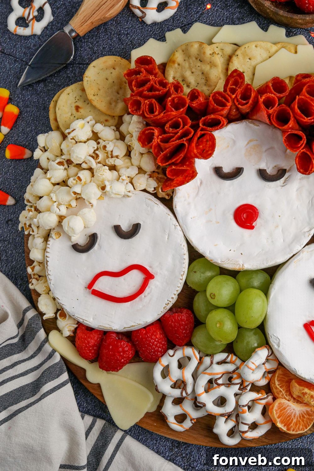 A beautifully completed Hocus Pocus Charcuterie Board, featuring the Sanderson Sisters Brie arrangement surrounded by an abundance of crackers, fruits, and Halloween-themed snacks, ready for serving.
