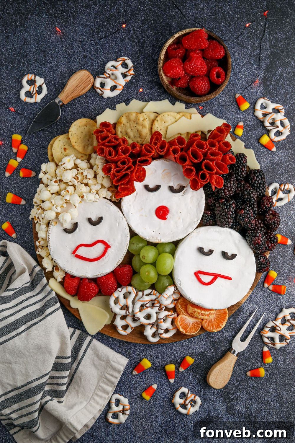 A delightful Hocus Pocus themed snack board overflowing with various treats, beautifully arranged on a table with additional snacks around it, creating a festive party spread.