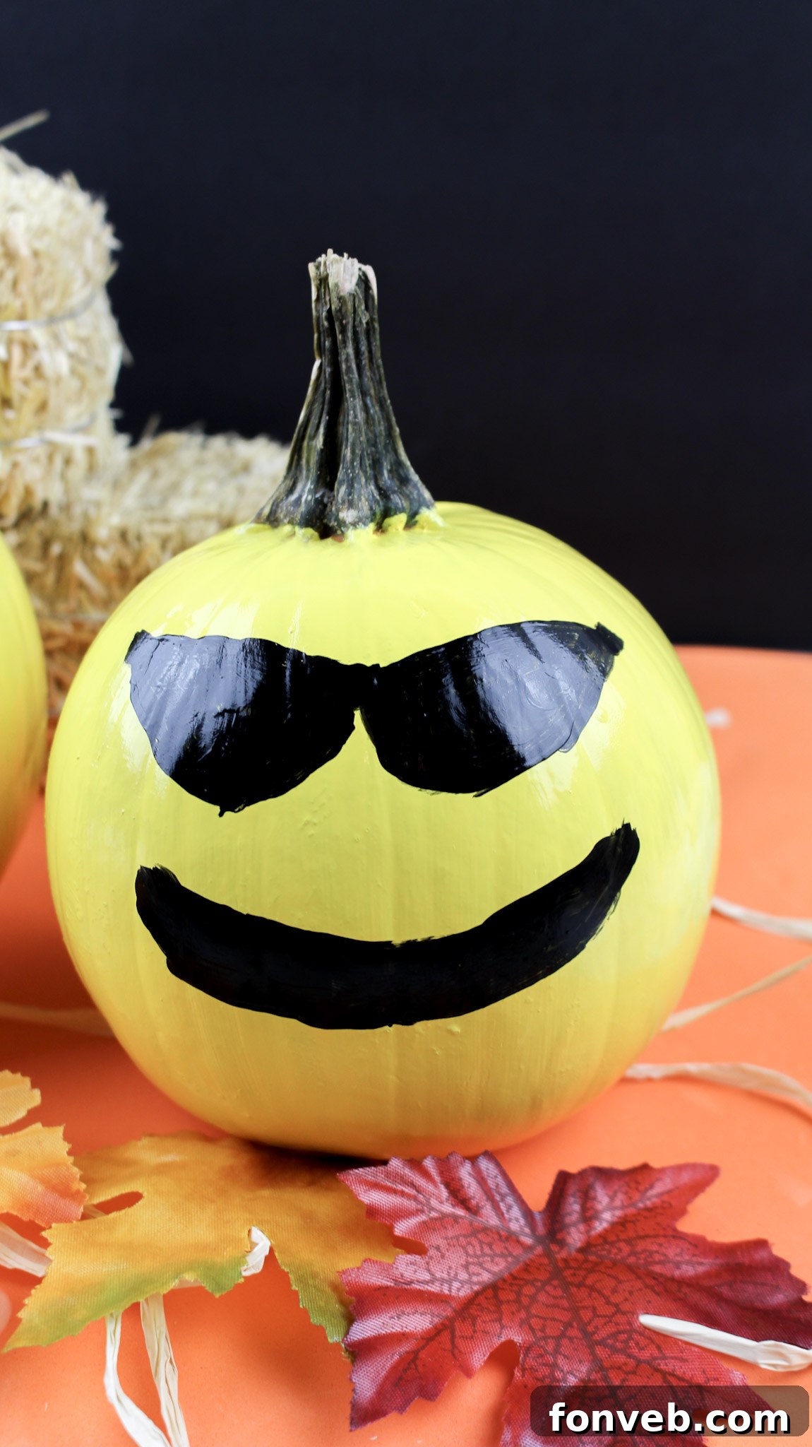 Pumpkins with Personality 11 A painted pumpkin with a cool winking face and a slight smirk, radiating a playful and confident emoji expression.